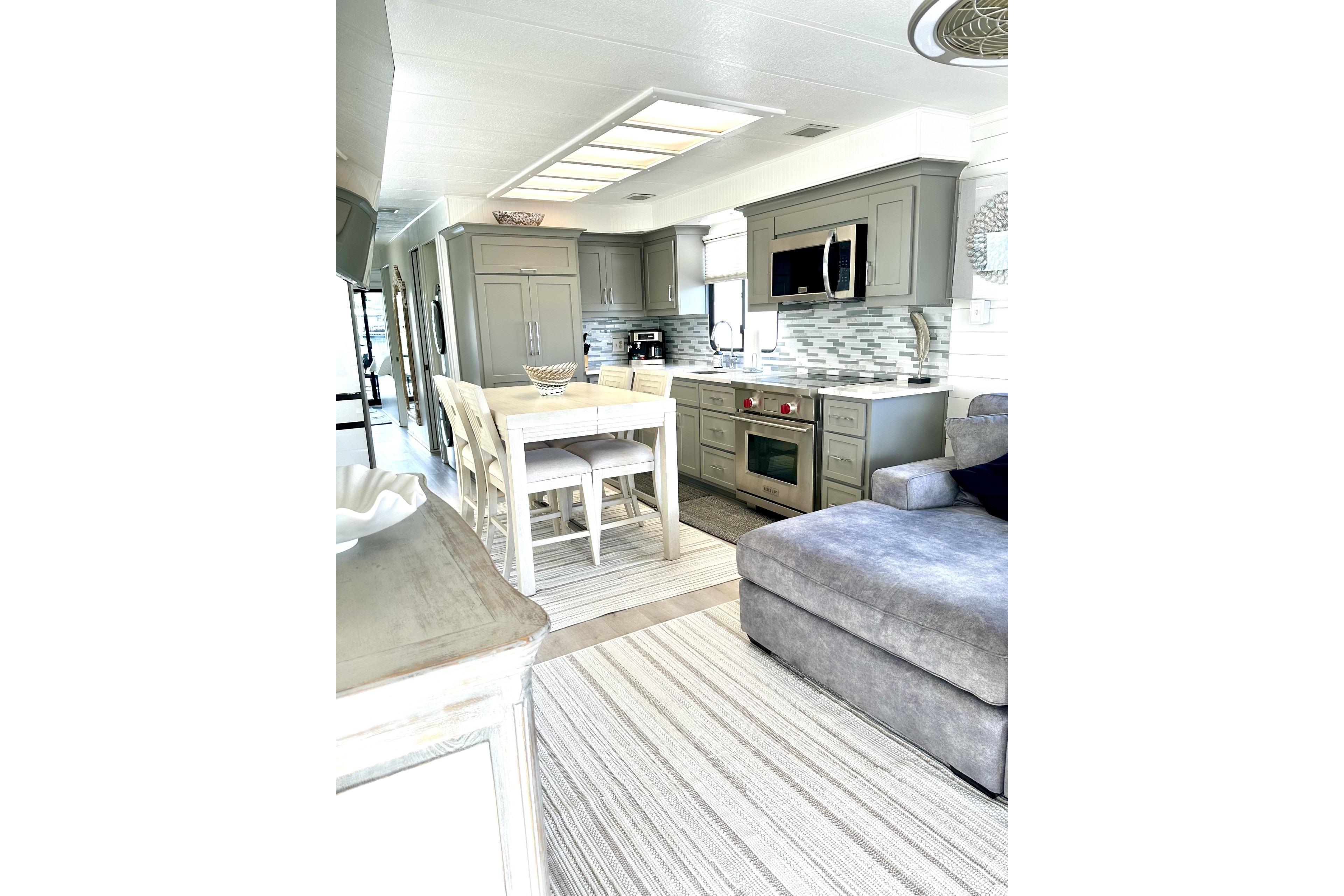 Modern kitchen interior in a 1992 Sumerset 66 houseboat with sleek cabinetry and dining area.