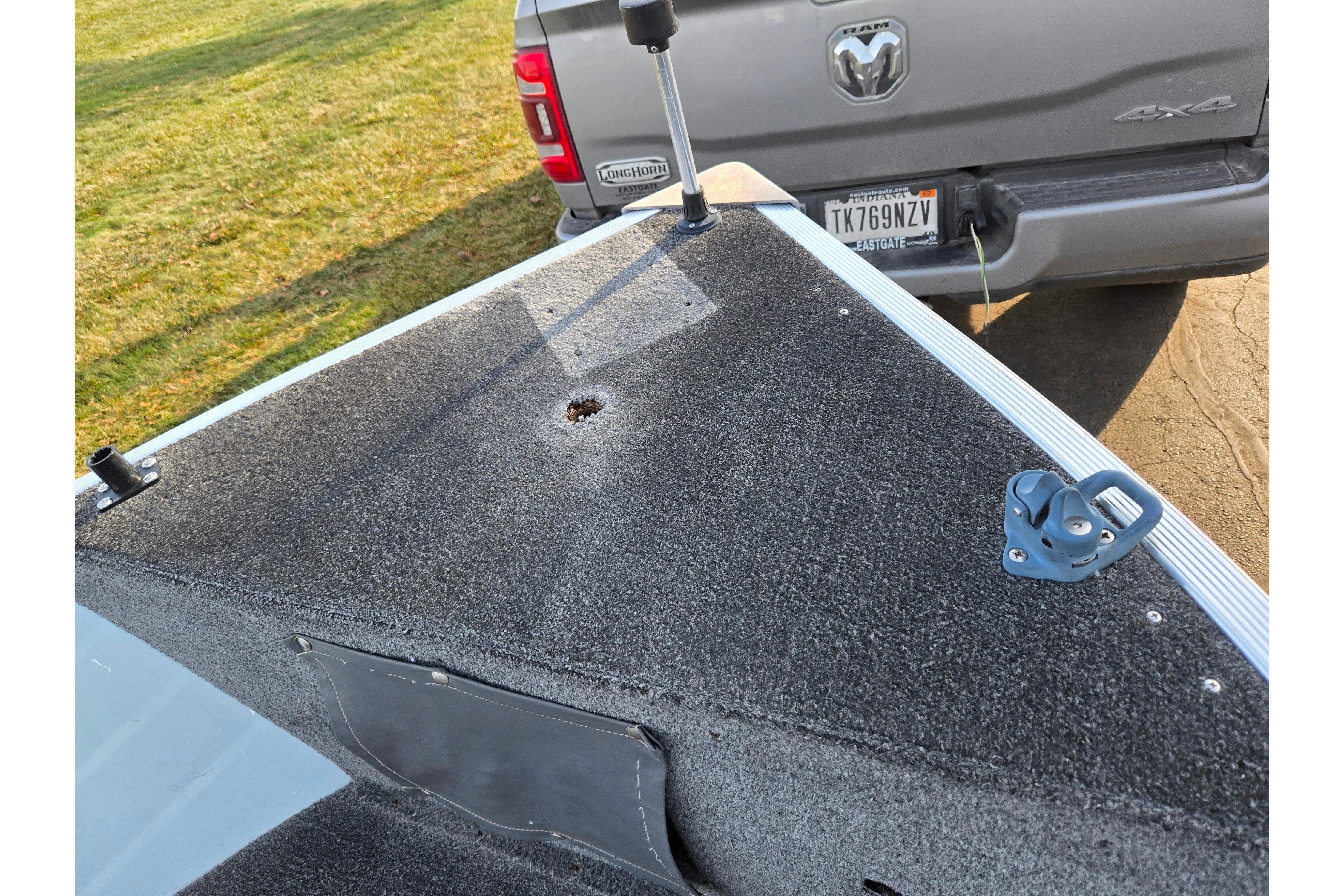 1994 Tracker Pro Deep V-16 boat deck near a parked truck.