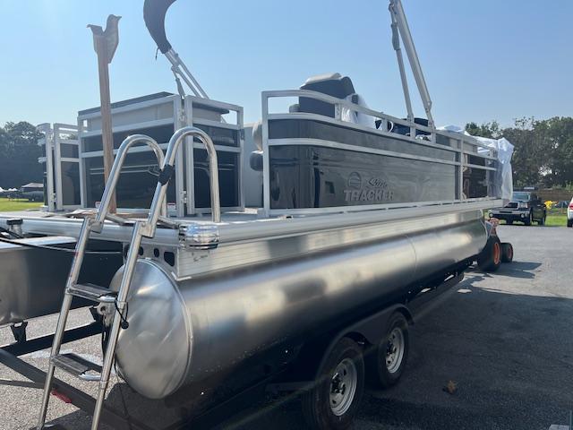 2026 Sun Tracker Fishin' Barge 20 DLX pontoon boat on trailer, side view.