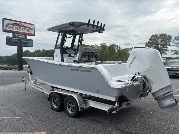 2025 Sportsman Open 232 boat on trailer, parked outdoors near dealership sign.