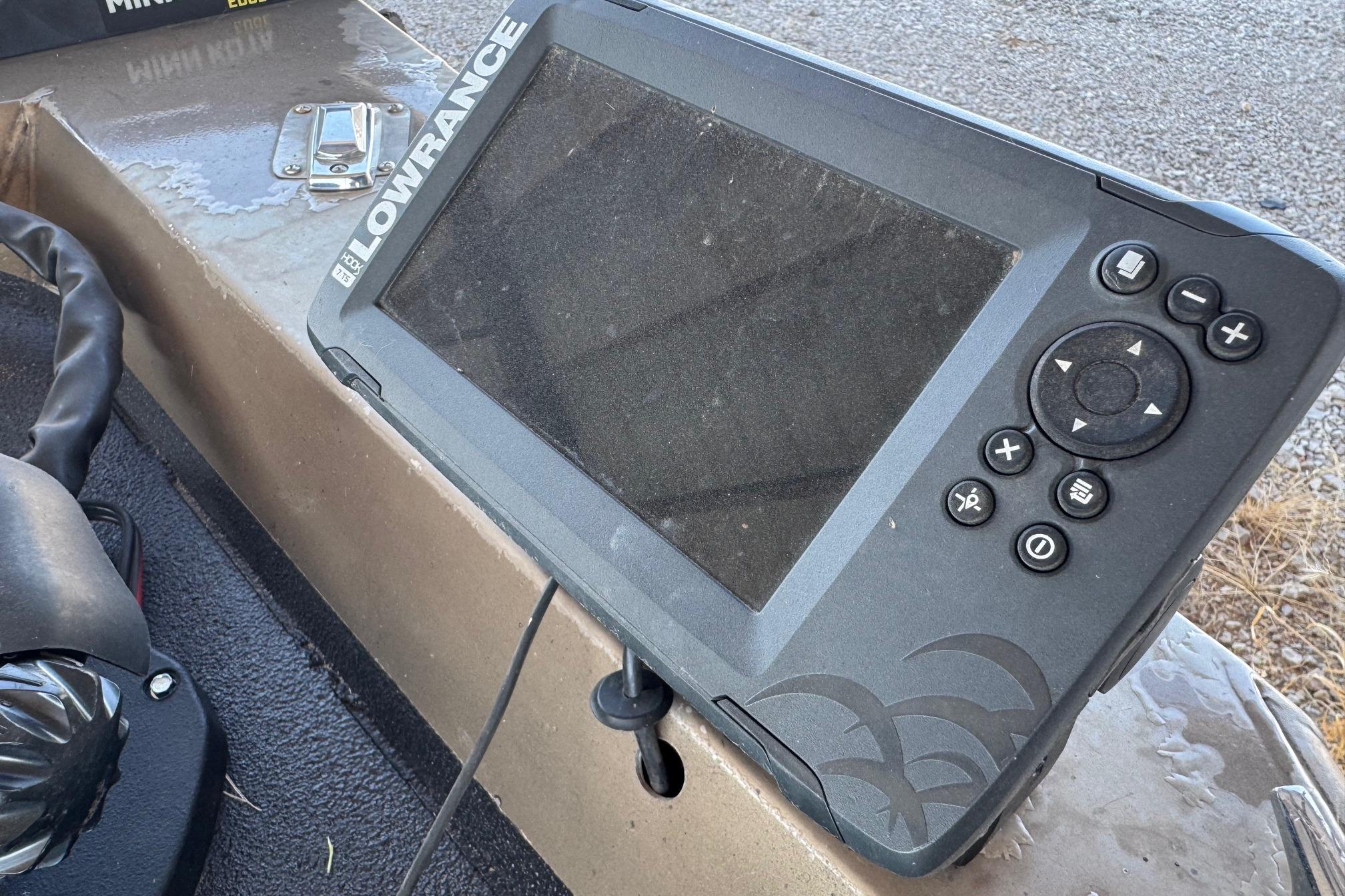 Fishfinder device on Xpress X51 boat, 2001 model, with control buttons and display screen.
