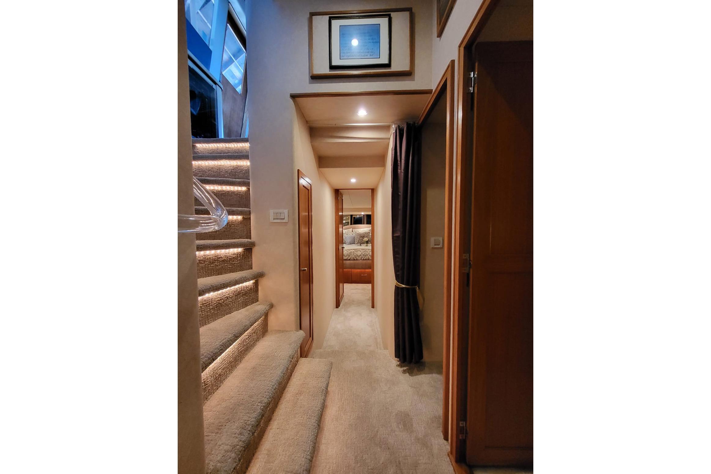 Interior of 1999 Pacific Mariner 65 Motoryacht with carpeted stairs and cozy hallway.
