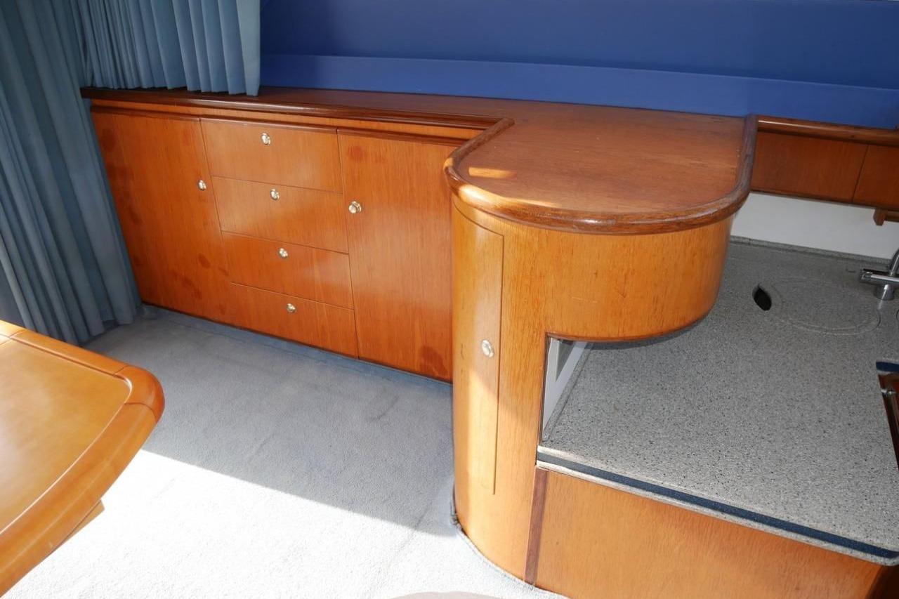 Interior of 1994 Fairline Phantom 37 yacht with wooden cabinetry and countertop.