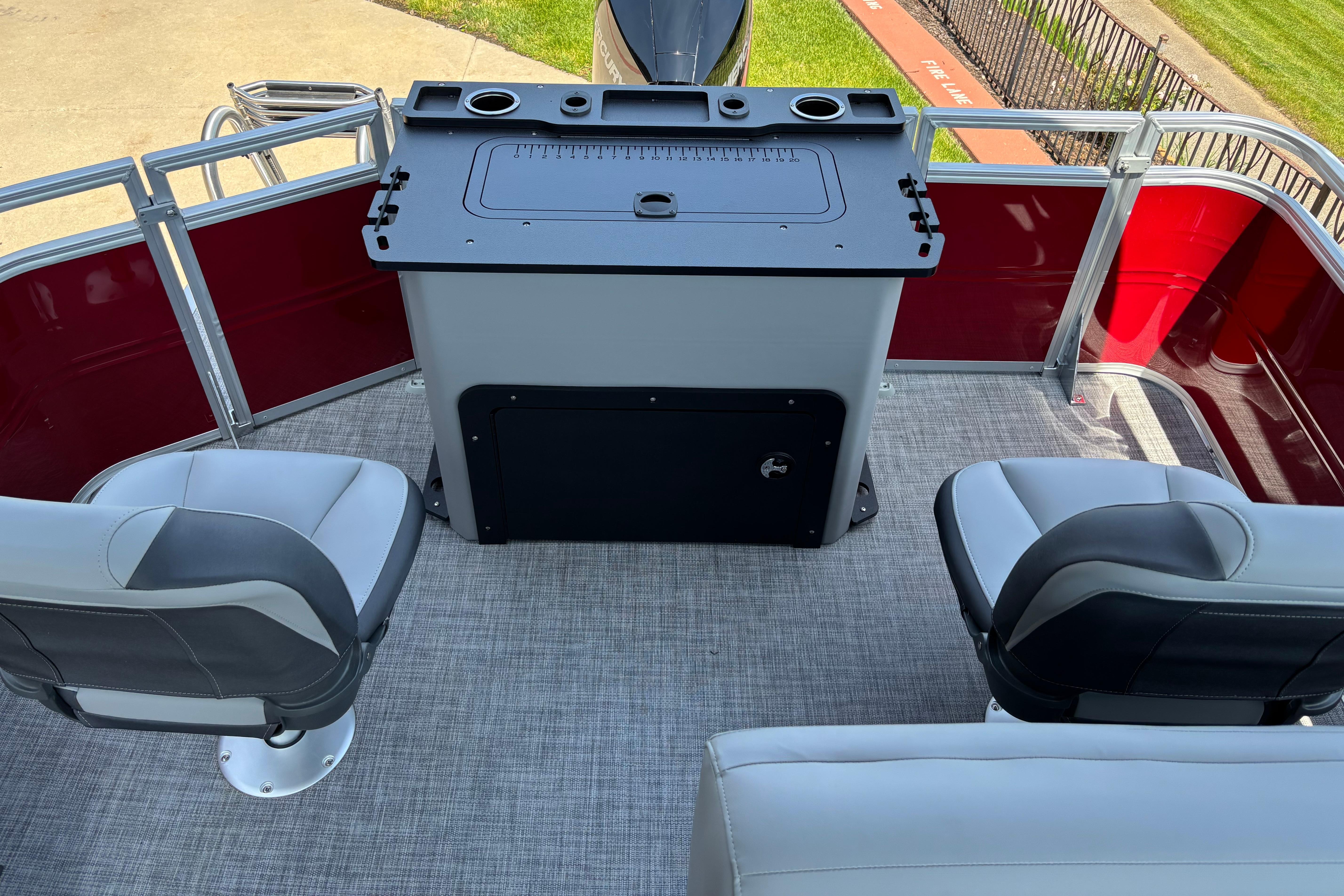 2026 Sun Tracker SportFish 22 XP3 boat interior with seating and fishing station.