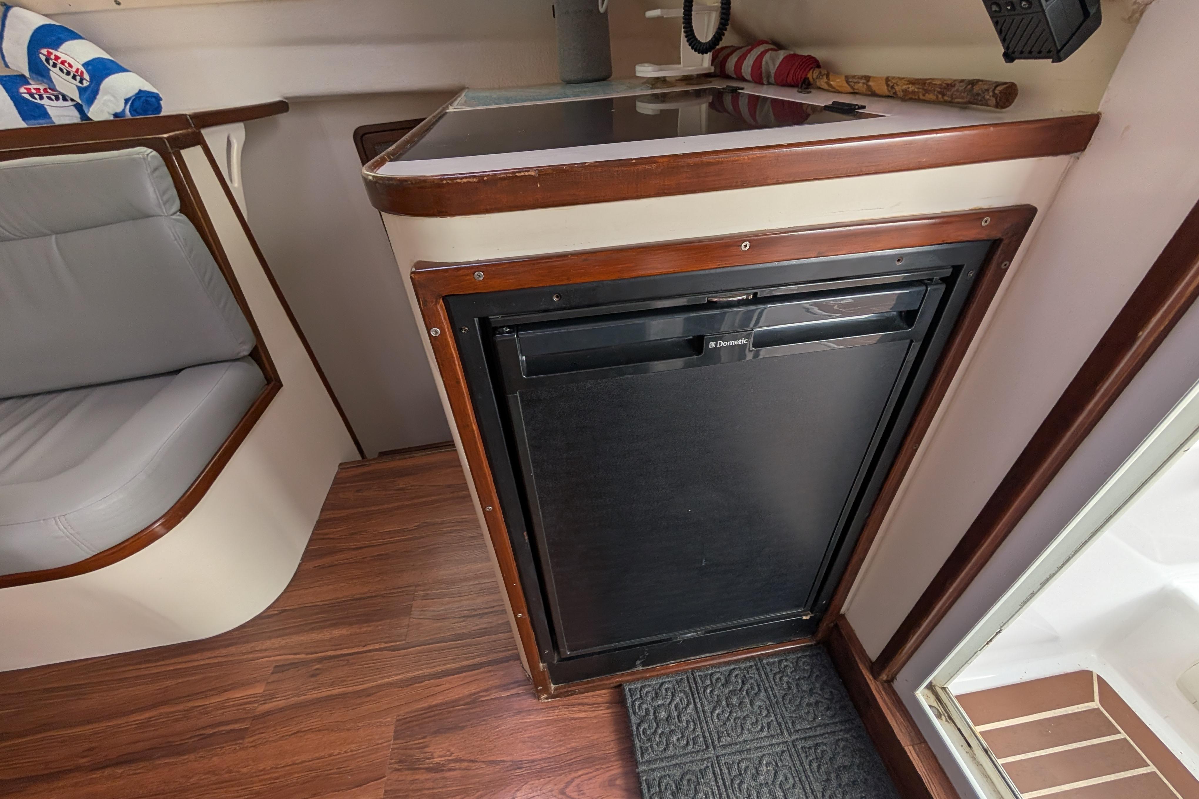 Interior of a 1999 Island Spirit 37 yacht featuring a compact kitchen area.