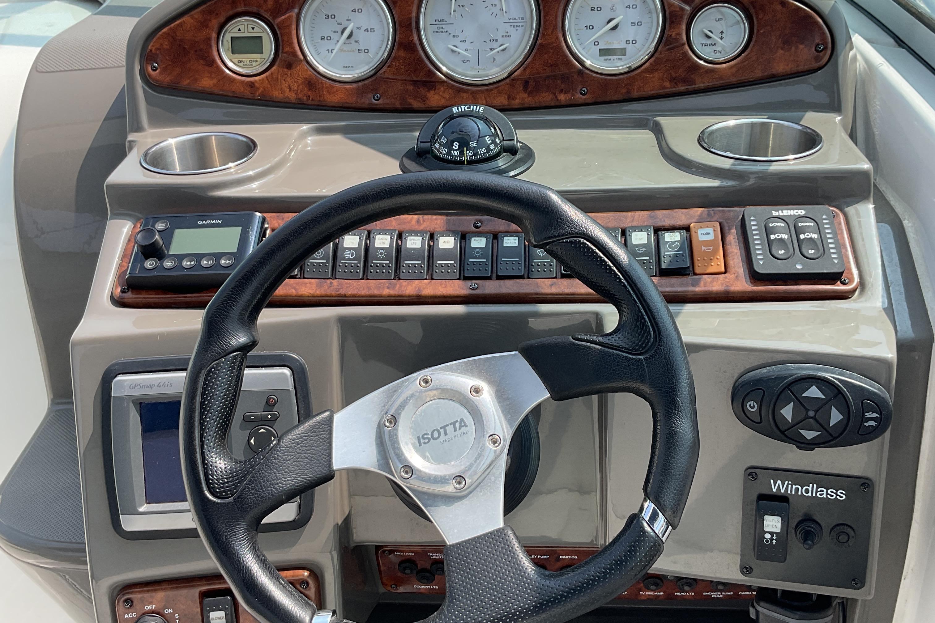 2013 Rinker 290 Express Cruiser dashboard with steering wheel and control panel.