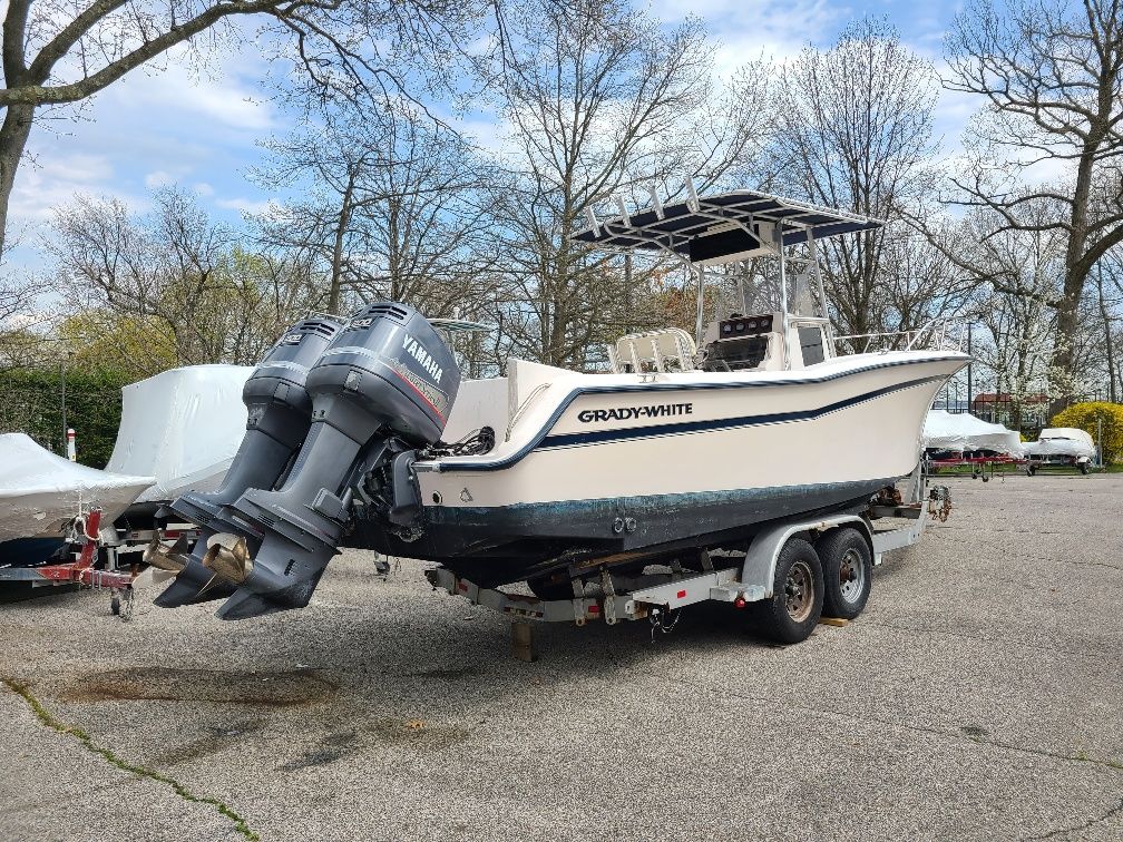 1997 Grady-White Chase 263 on a trailer with twin outboard engines.
