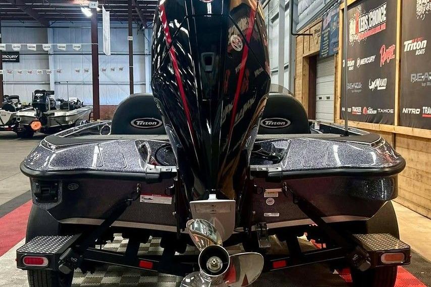 2026 Triton 18 TrX boat in showroom, rear view with powerful engine.