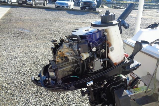 2007 Sanibel 18 Pocket Cruiser outboard motor, detailed view in a parking lot.