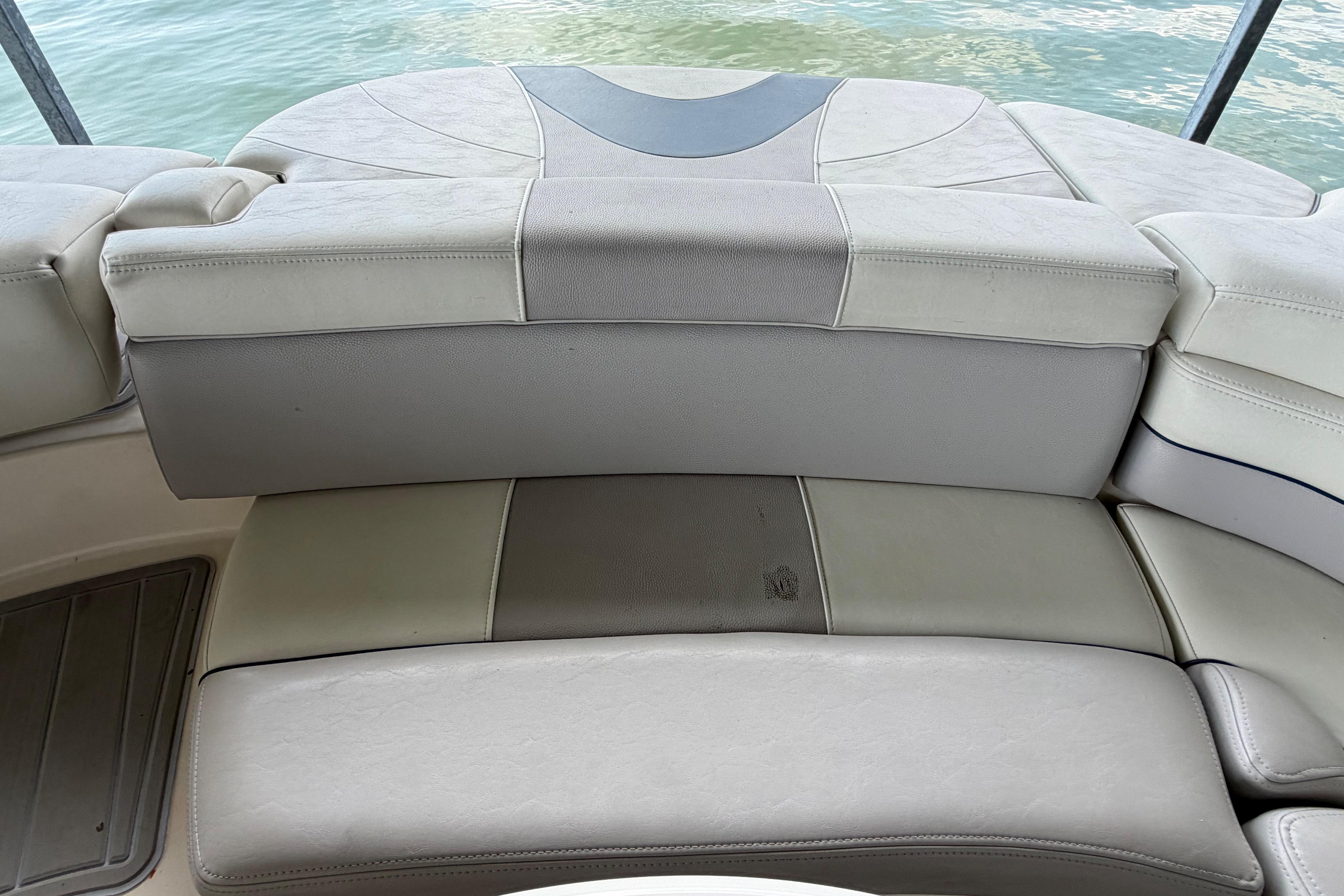 Rear seating area of a 2010 Bryant 255 boat with beige upholstery.