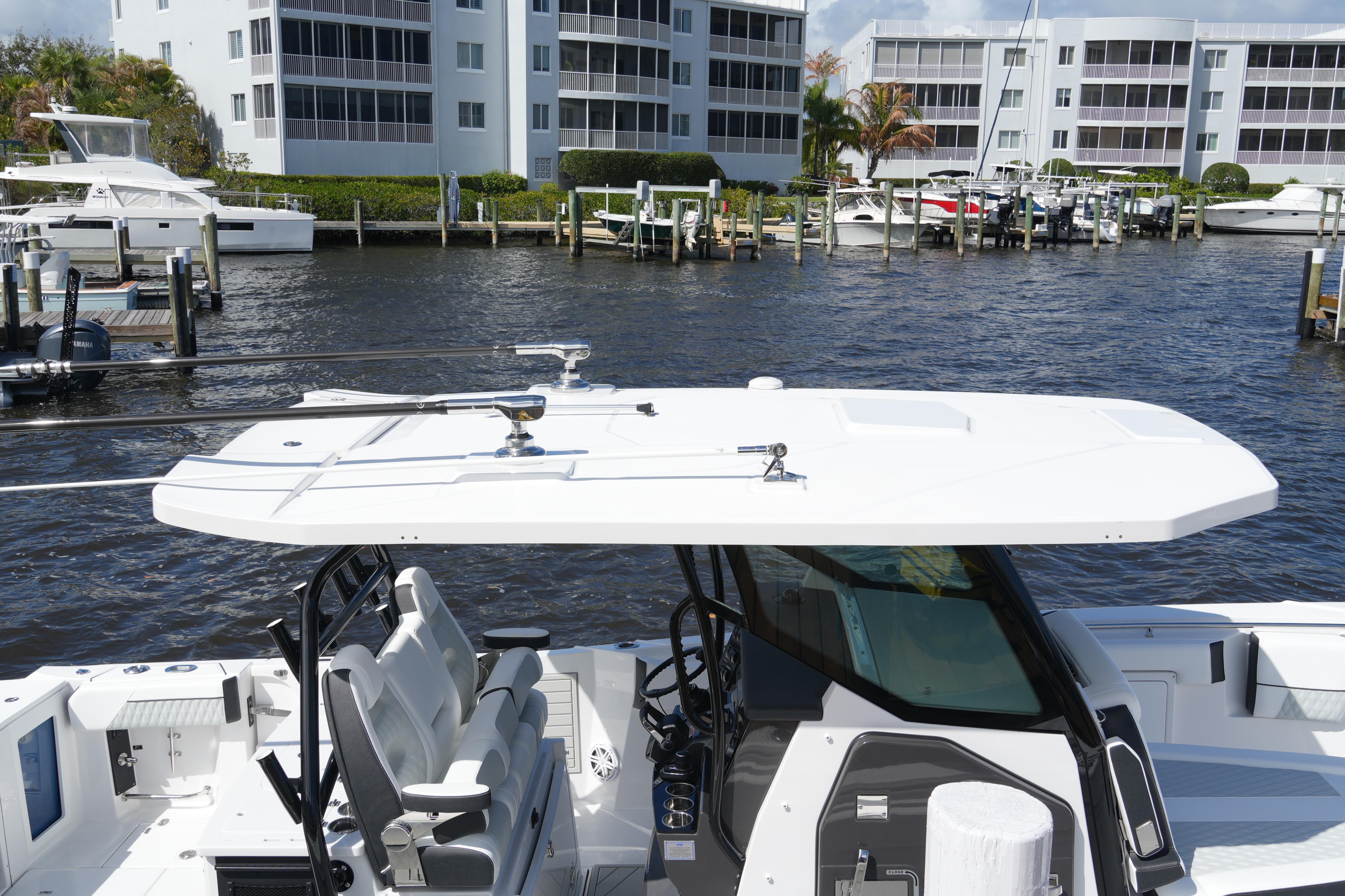 2026 Blackfin 332 CC boat docked near waterfront buildings.