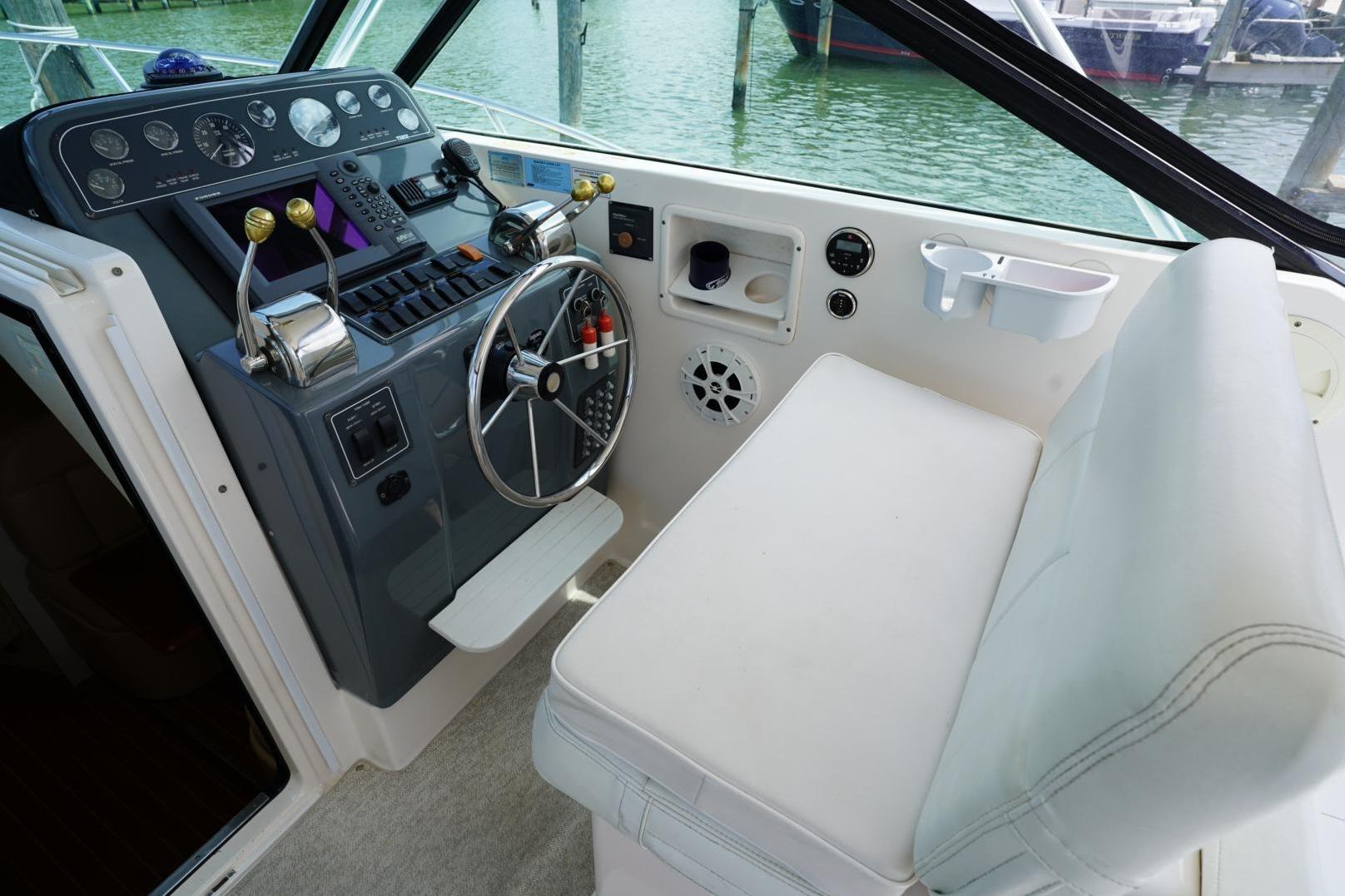 2004 Tiara Yachts 2900 Open Classic helm with steering wheel and controls.
