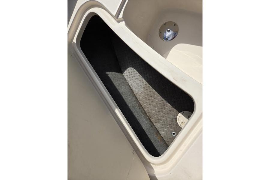 Storage compartment of 2015 Grady-White Freedom 205 boat, featuring diamond-patterned flooring.
