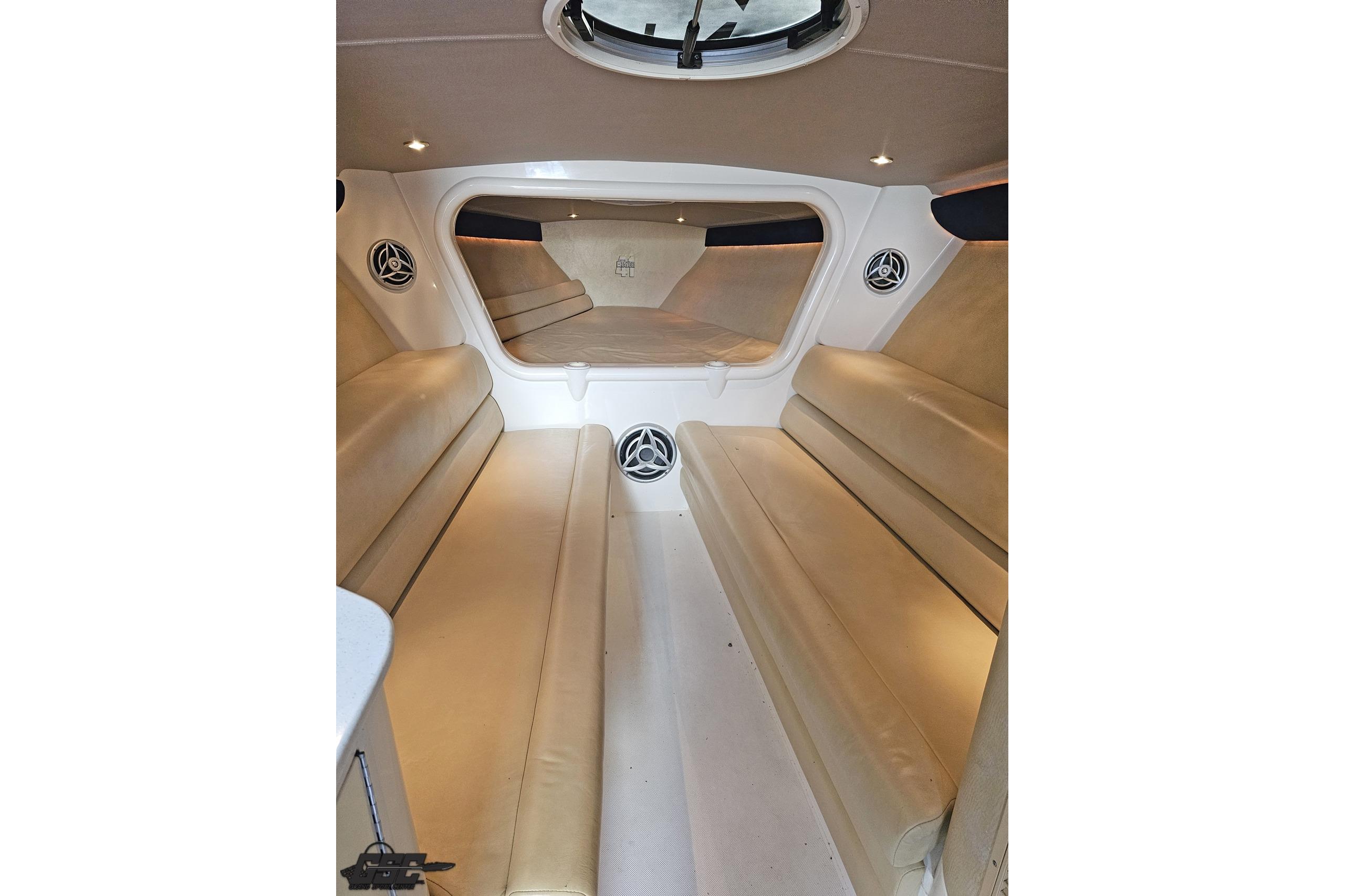 Interior of 2007 Hustler 41 Razor boat with beige seating and speakers.