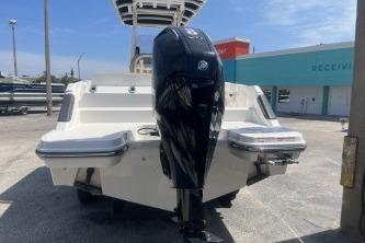 2023 Trophy T24 CC boat with powerful outboard motor, docked outdoors.