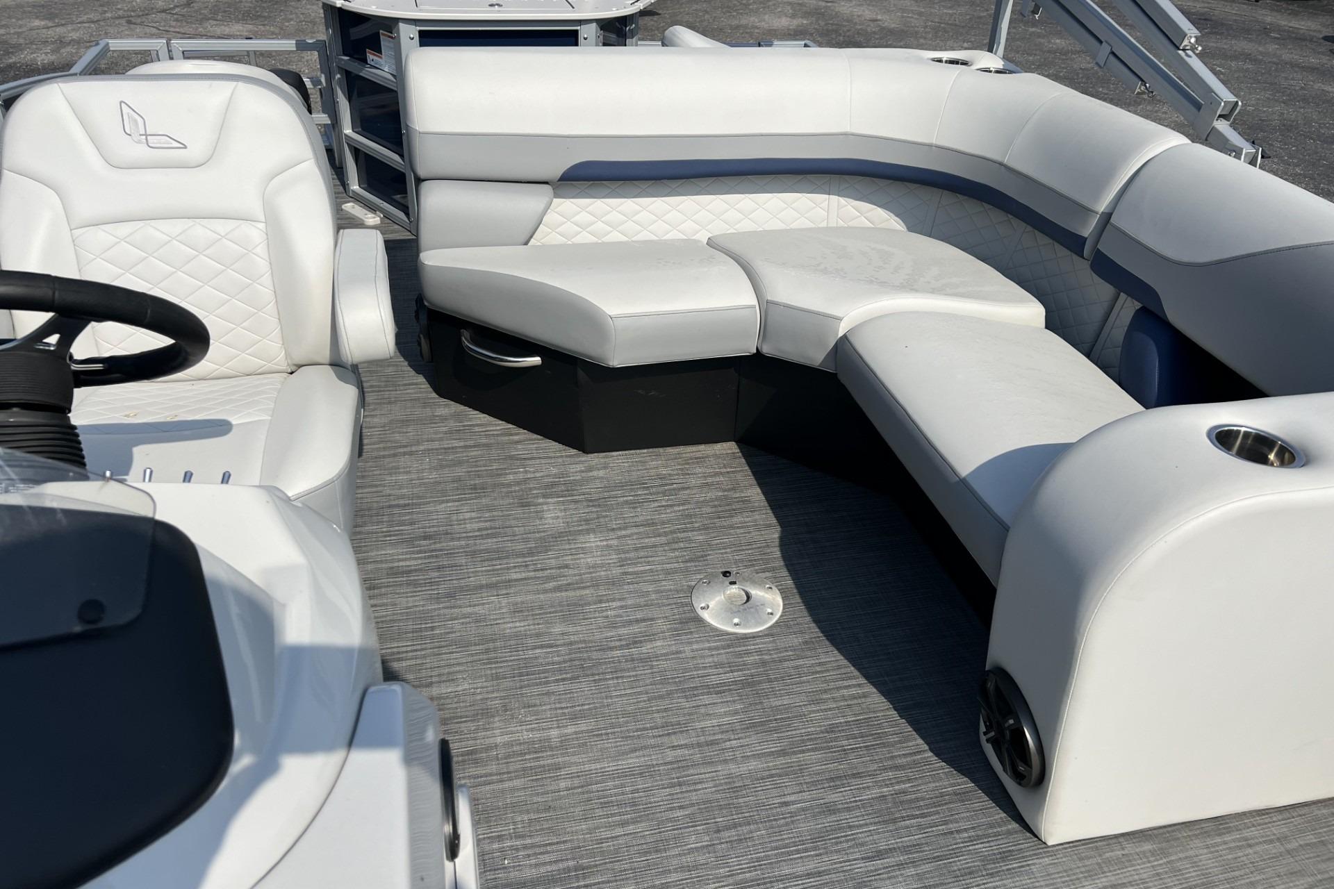 2024 Lowe SF 214 Sport Fish boat interior with white cushioned seating and steering area.