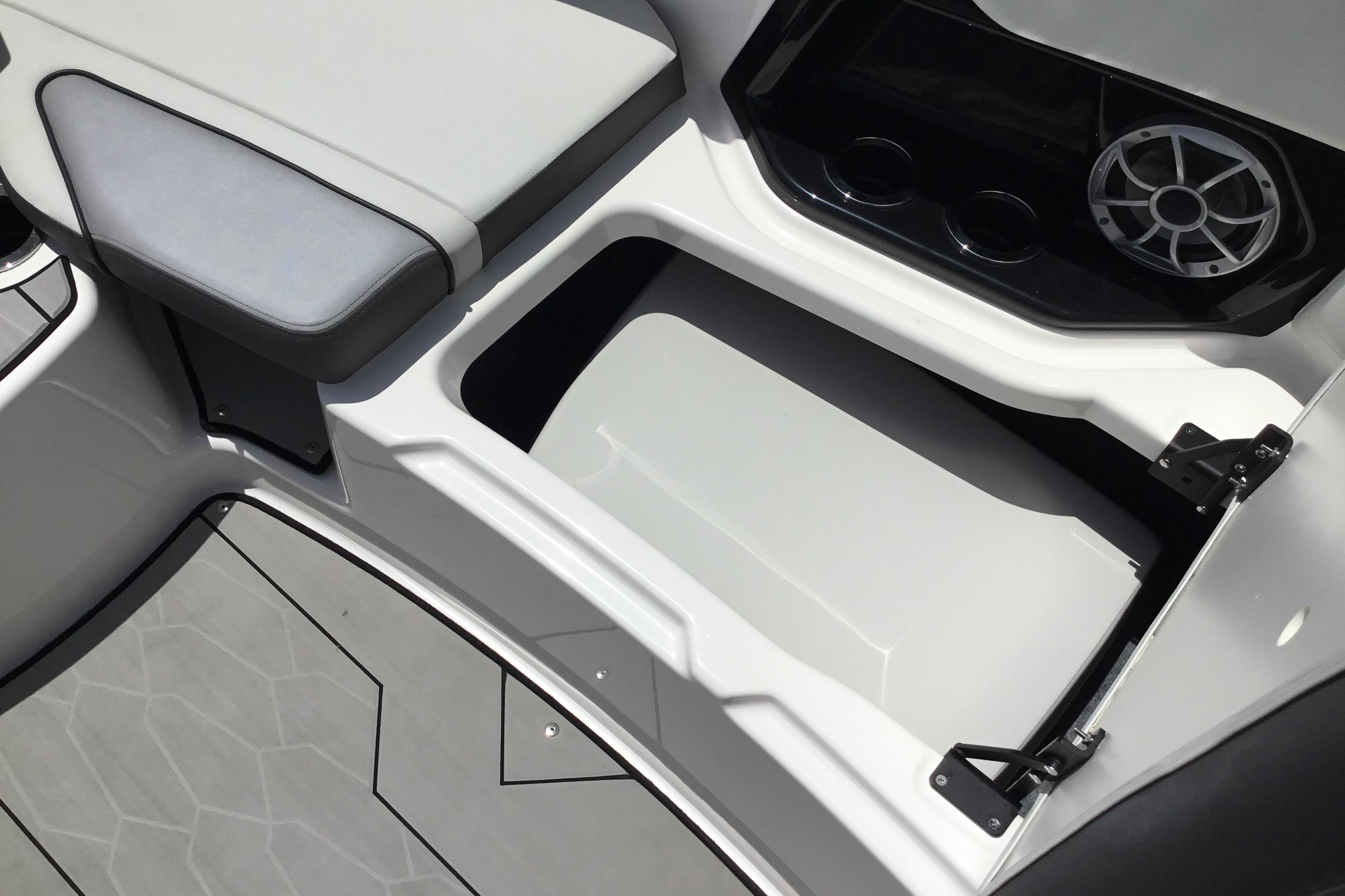 2023 Yamaha Boats 252XE interior storage compartment with speaker and cup holders.
