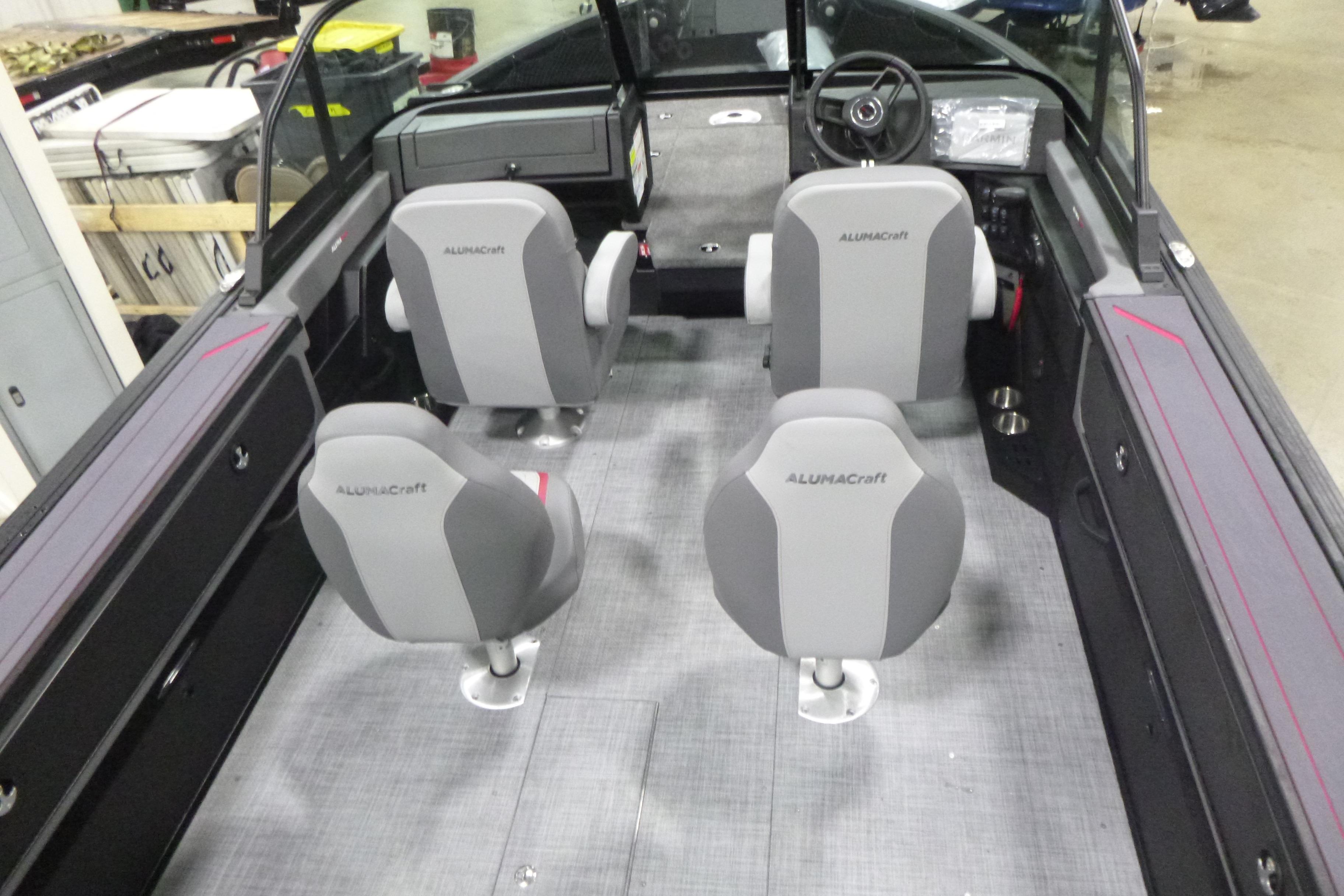 2026 Alumacraft Trophy 205X Sport boat interior with four gray seats and steering console.