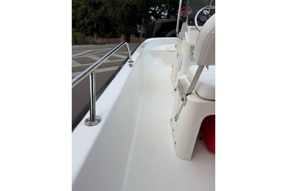 2016 Boston Whaler 150 Montauk boat interior with white seating and stainless steel railing.