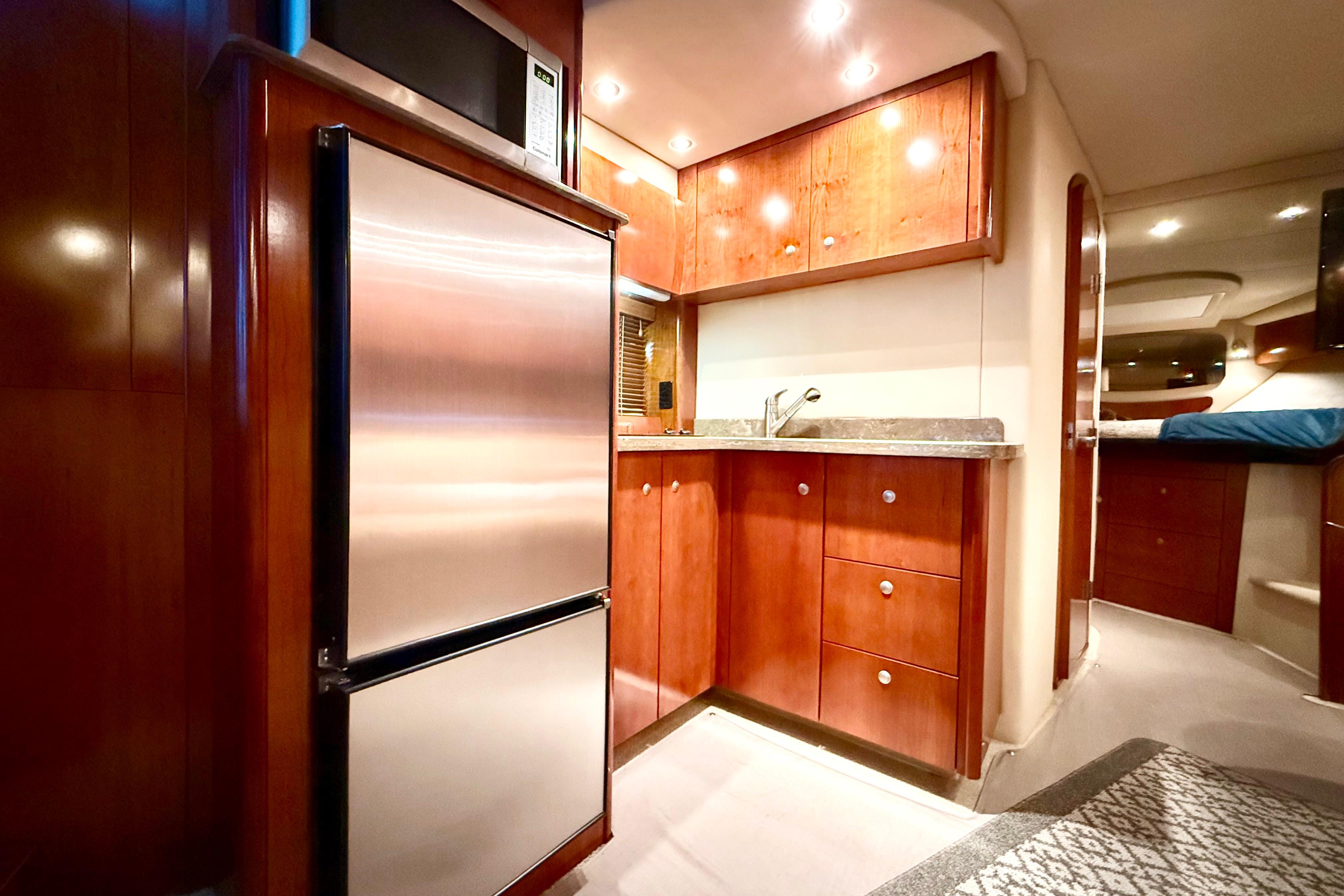 Luxurious interior of 2011 Cruisers Yachts 390 Sports Coupe with modern kitchen amenities.