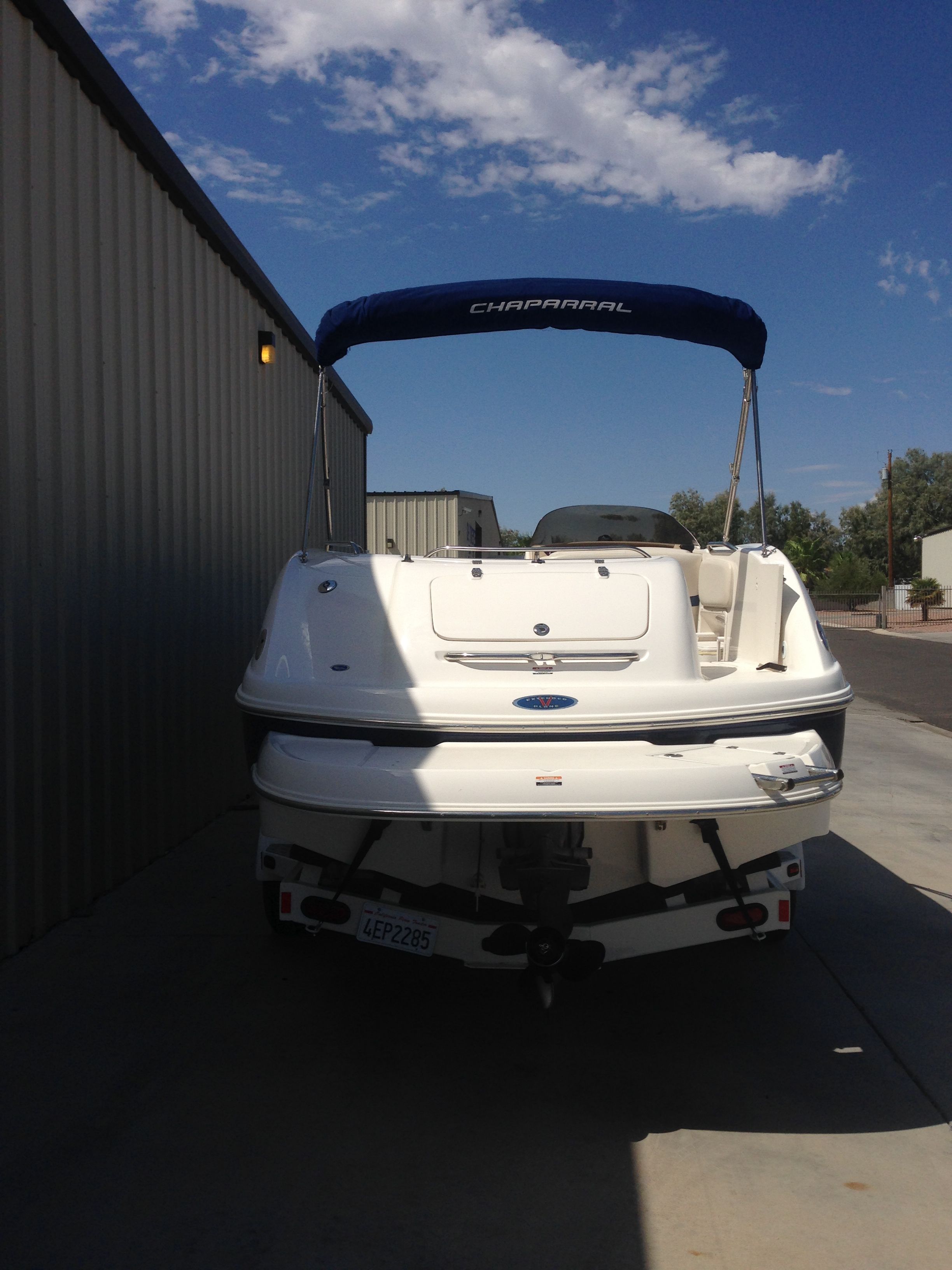 2003 Chaparral Sunesta 242 boat parked in shade.