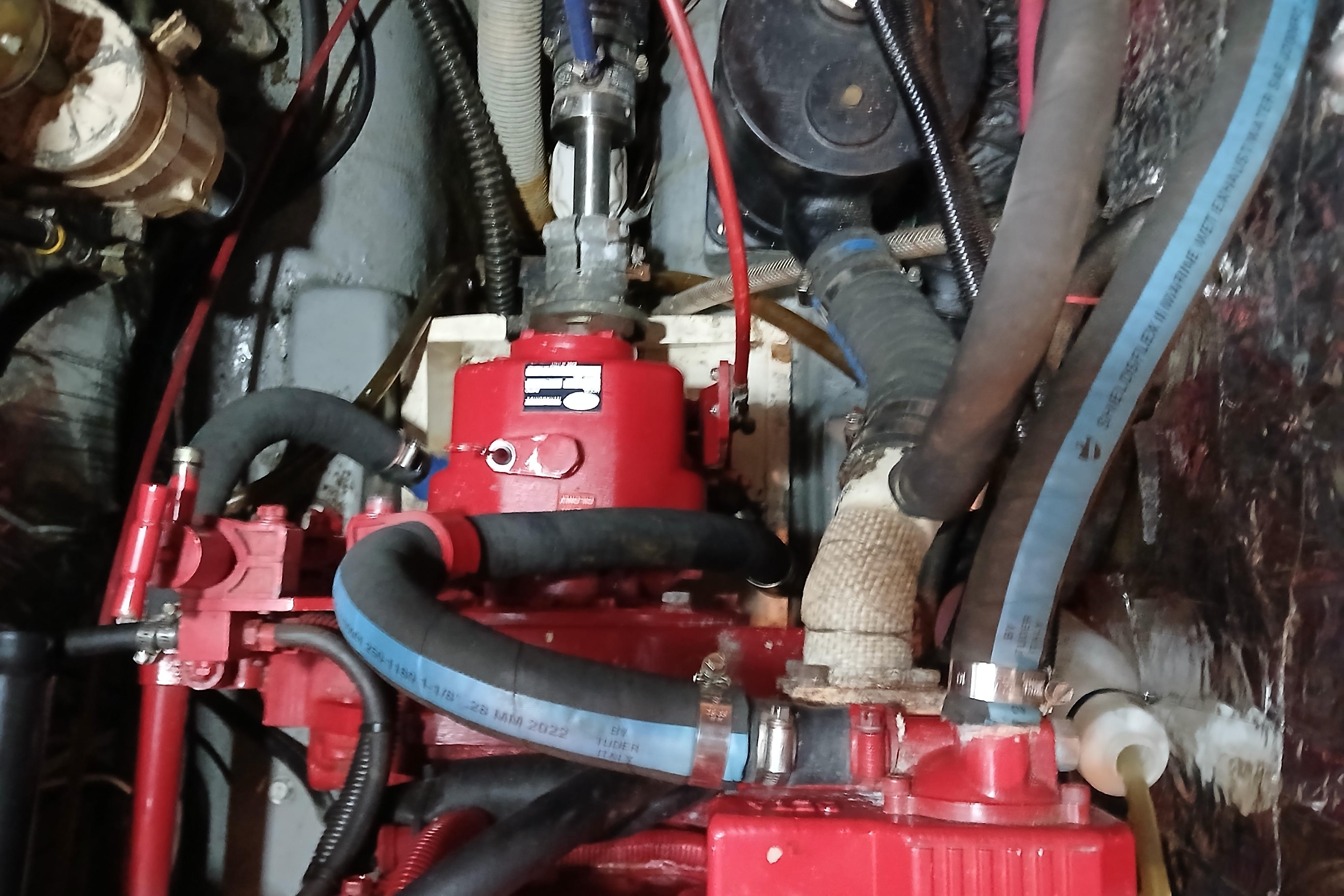 Engine compartment of a 1985 Kadey-Krogen 38 boat with visible hoses and components.