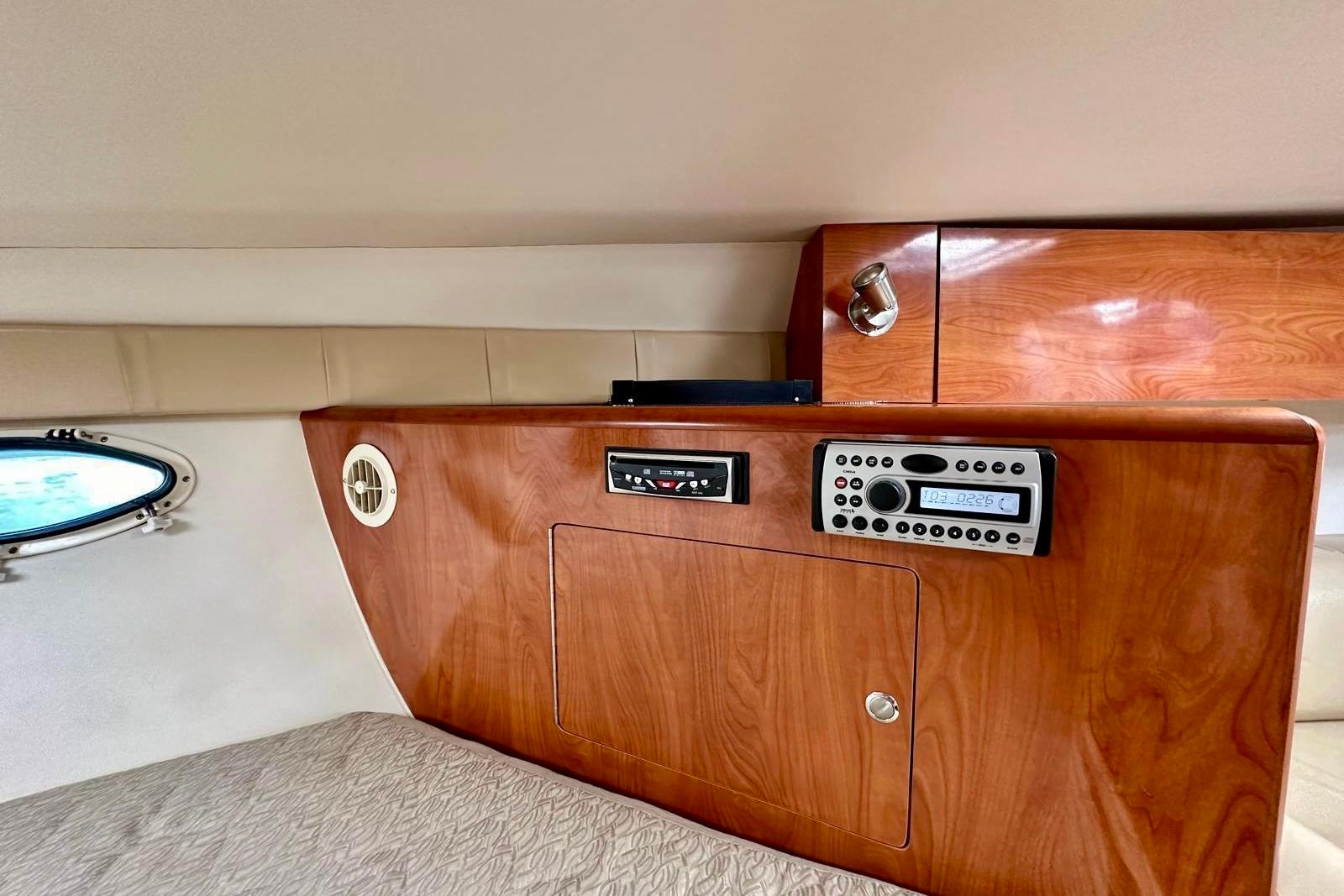 Interior of 2007 Larson Cabrio 330 Day Cruiser with wood paneling and control panel.