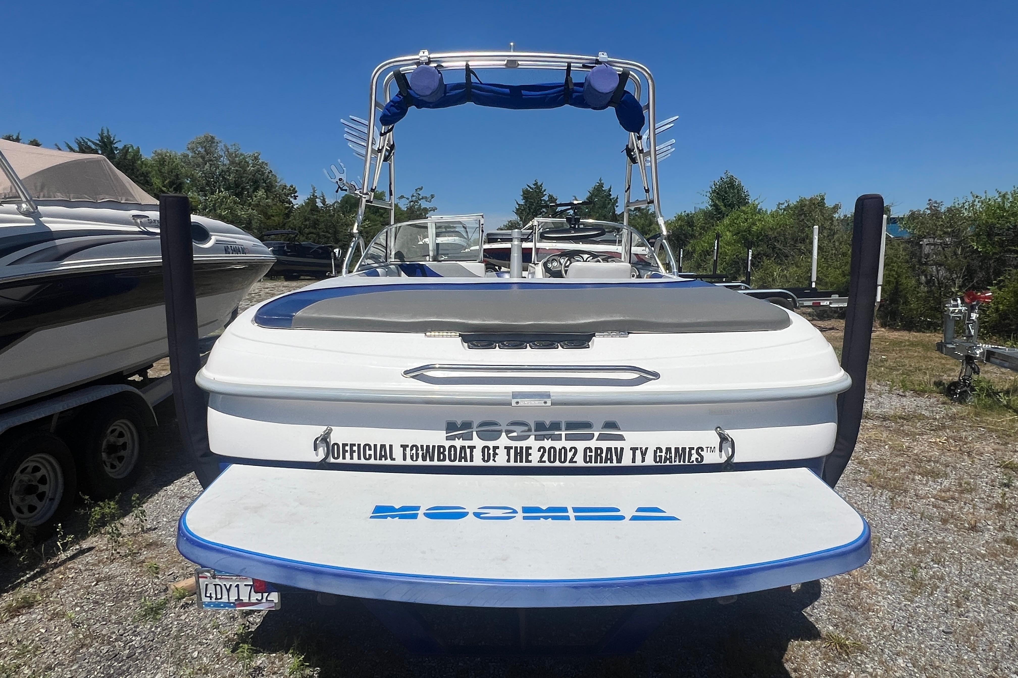 2002 Moomba Mobius LSV boat, official towboat of the 2002 Gravity Games, parked outdoors.