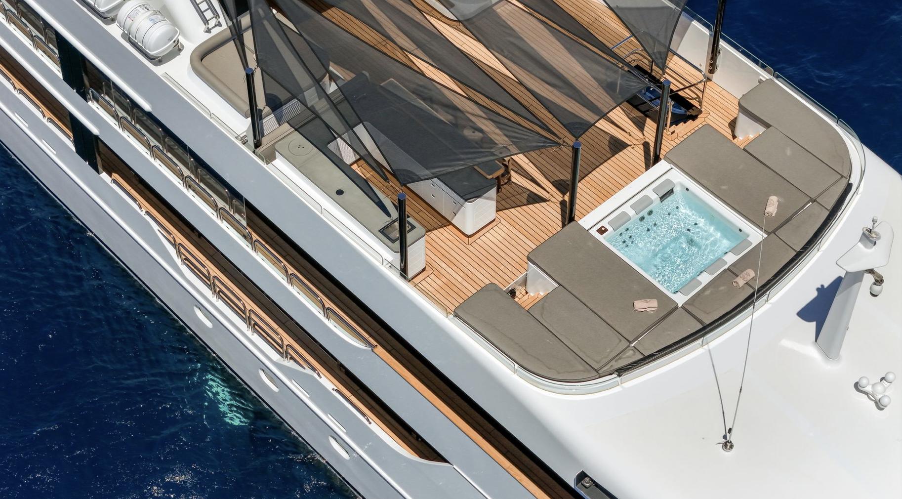 Luxurious yacht deck with hot tub, sun loungers, and canopy, Custom Elsflether Werft 1986.