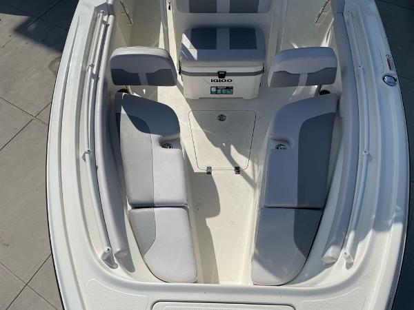 2024 Mako 214 CC boat interior with cushioned seating and storage.