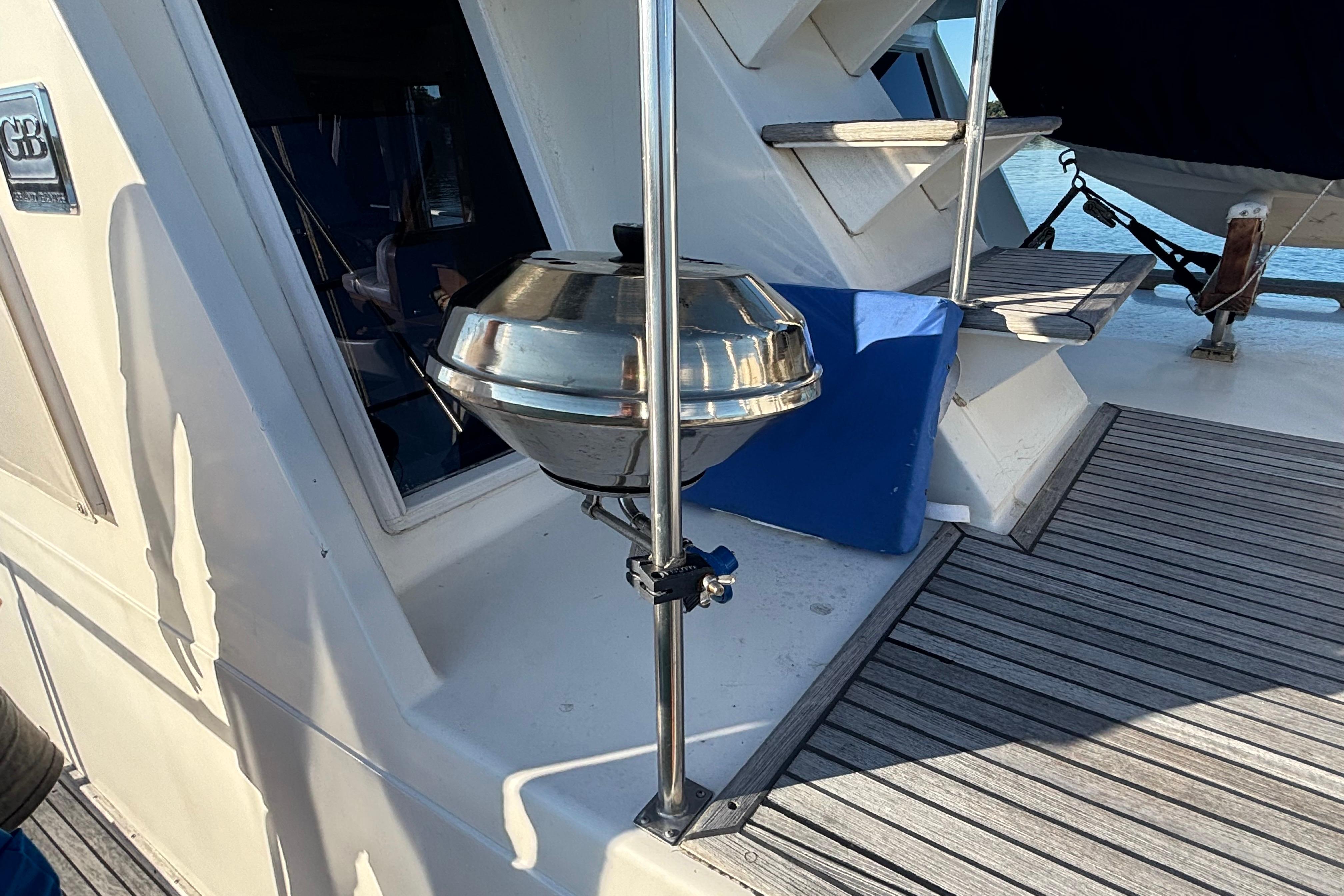1989 Grand Banks 46 Classic yacht deck with stainless steel grill and wooden flooring.