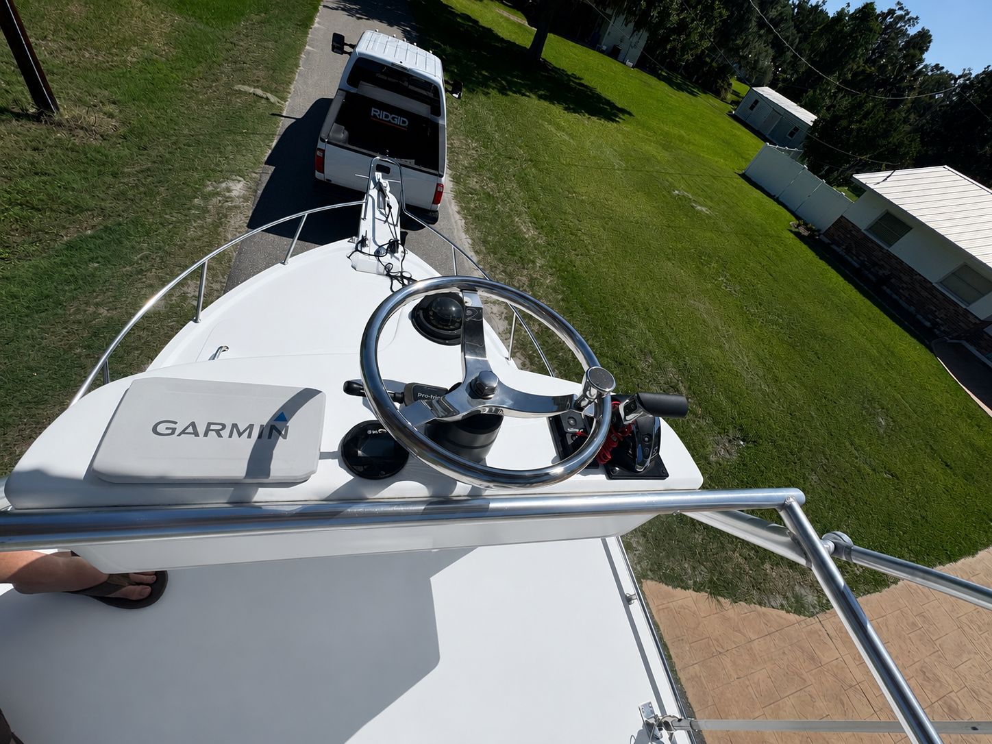 1997 Parker 2520 boat with Garmin controls, trailer in background.