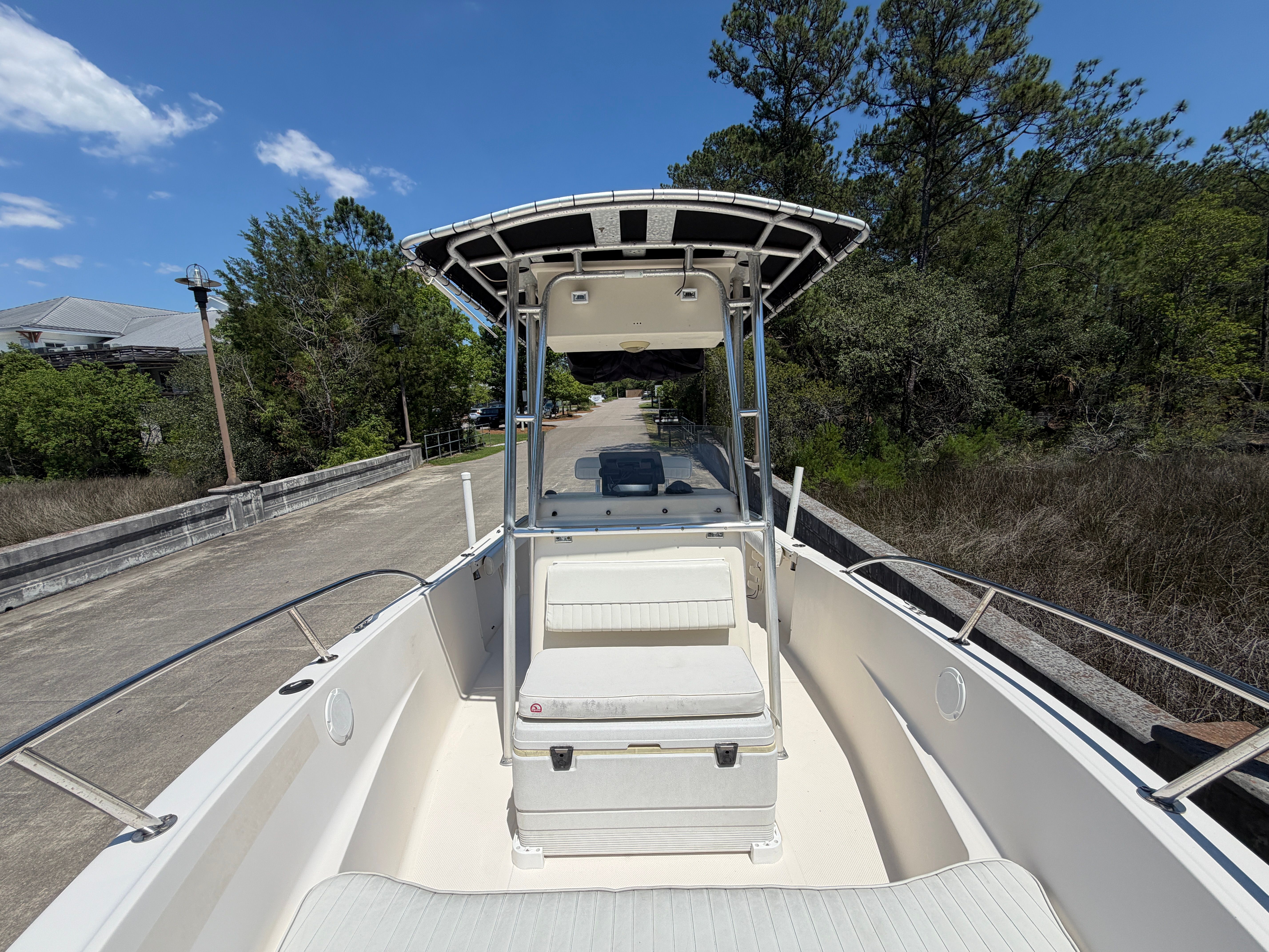 Key West 2020 Center Console boat on a road surrounded by trees.