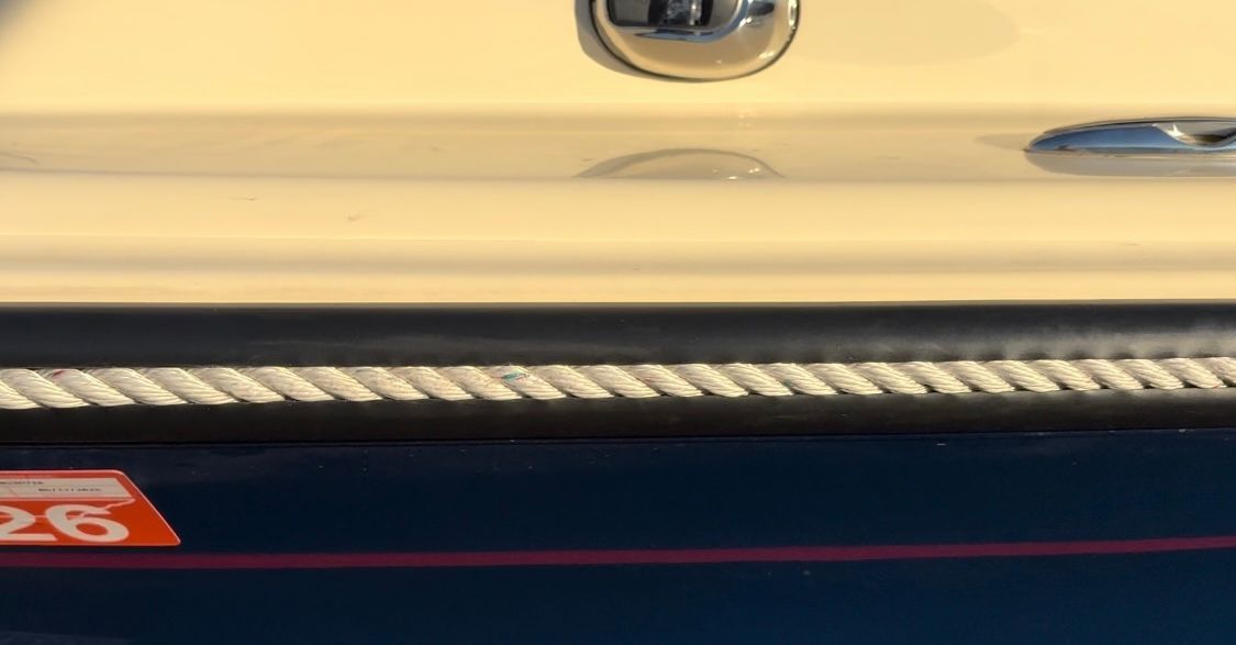 Close-up of a boat with rope and blue hull.