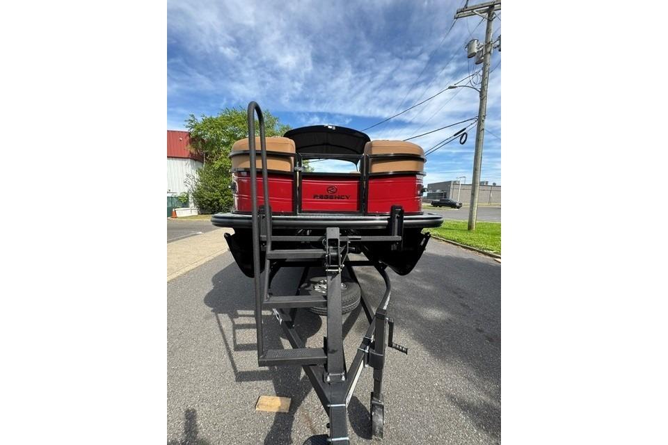 2026 Regency 230 DL pontoon boat on trailer, rear view, parked on street.