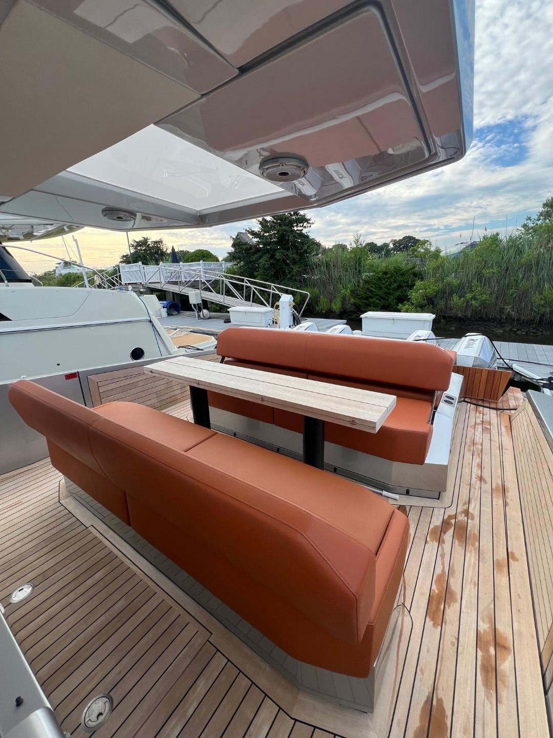 Luxury yacht Wally 48 X 2023 with elegant outdoor seating and wooden deck.