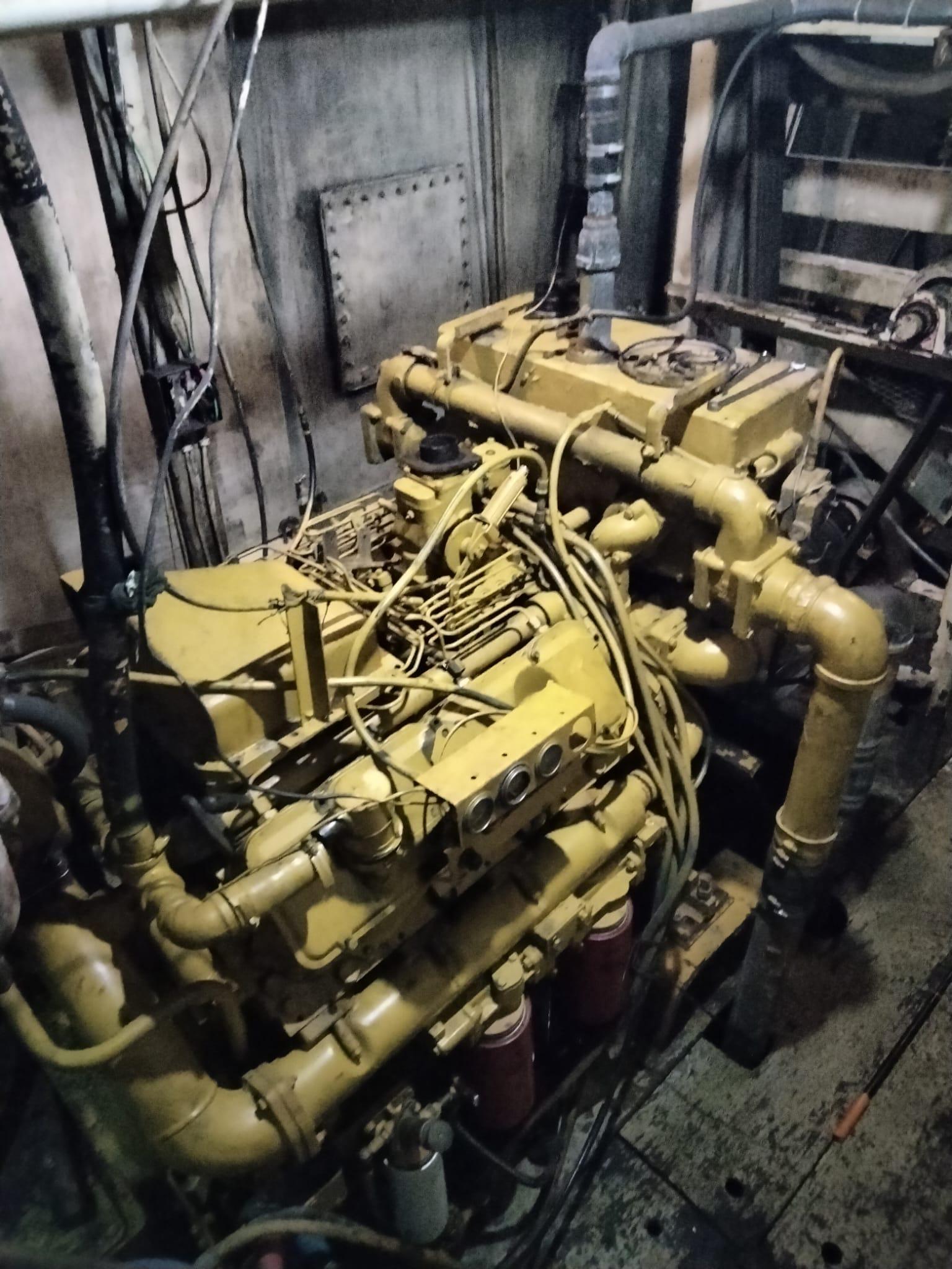 Engine room of a 1972 commercial shrimp freezer trawler, showcasing complex machinery and pipes.
