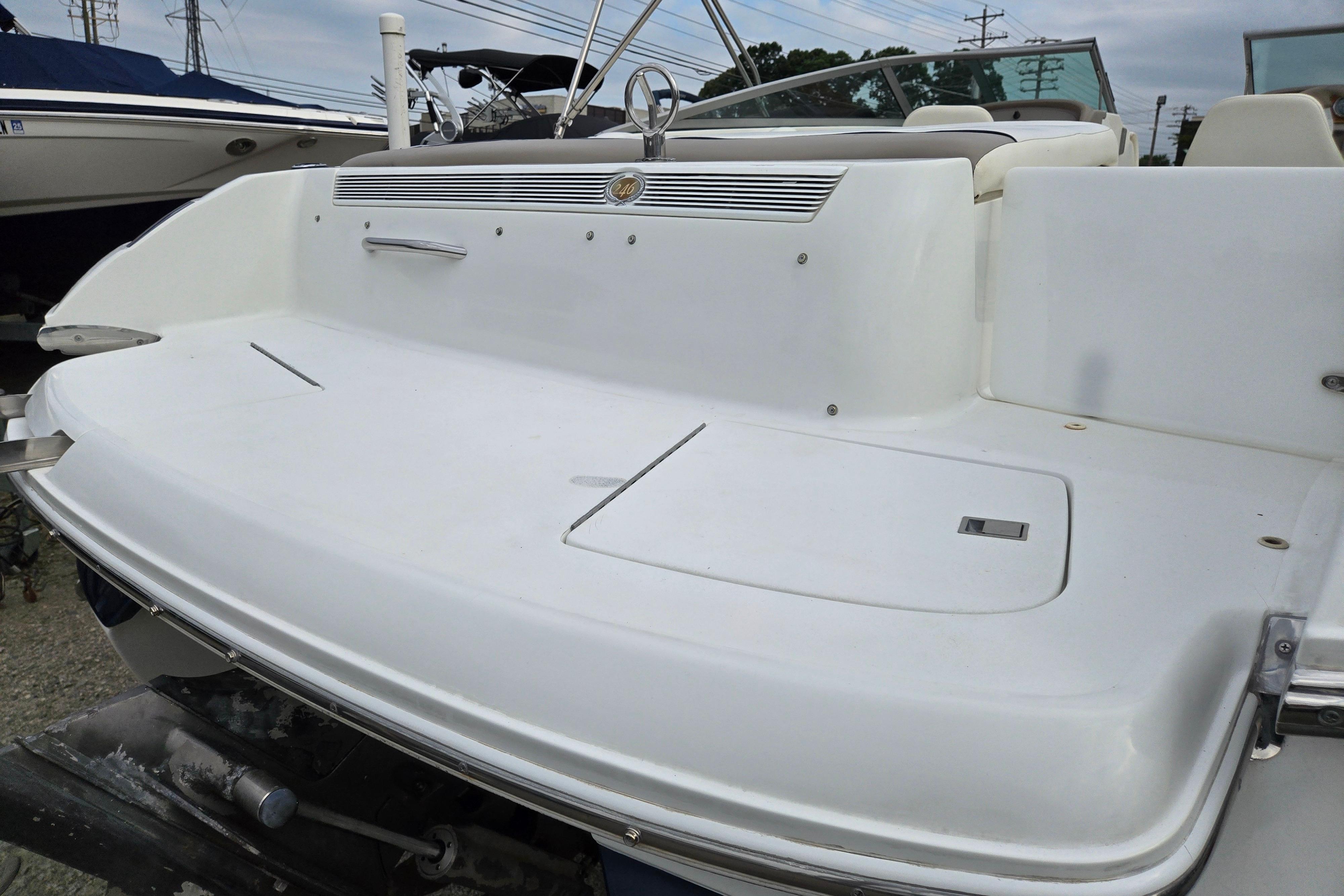 Rear view of a 2000 Cobalt 246 boat, showcasing its sleek white deck design.