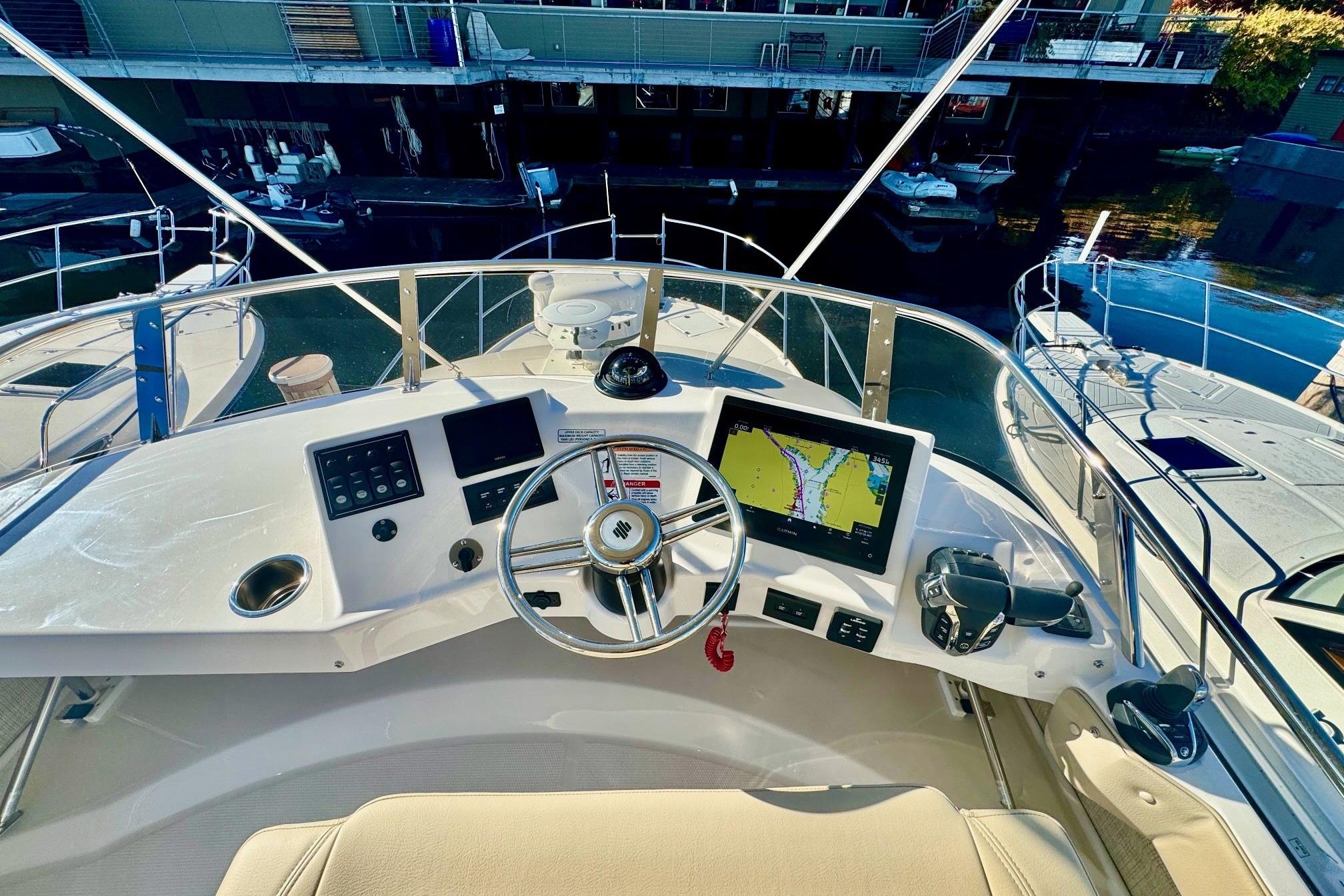 Helm of 2026 Cutwater C-32 CB boat with navigation display and controls.