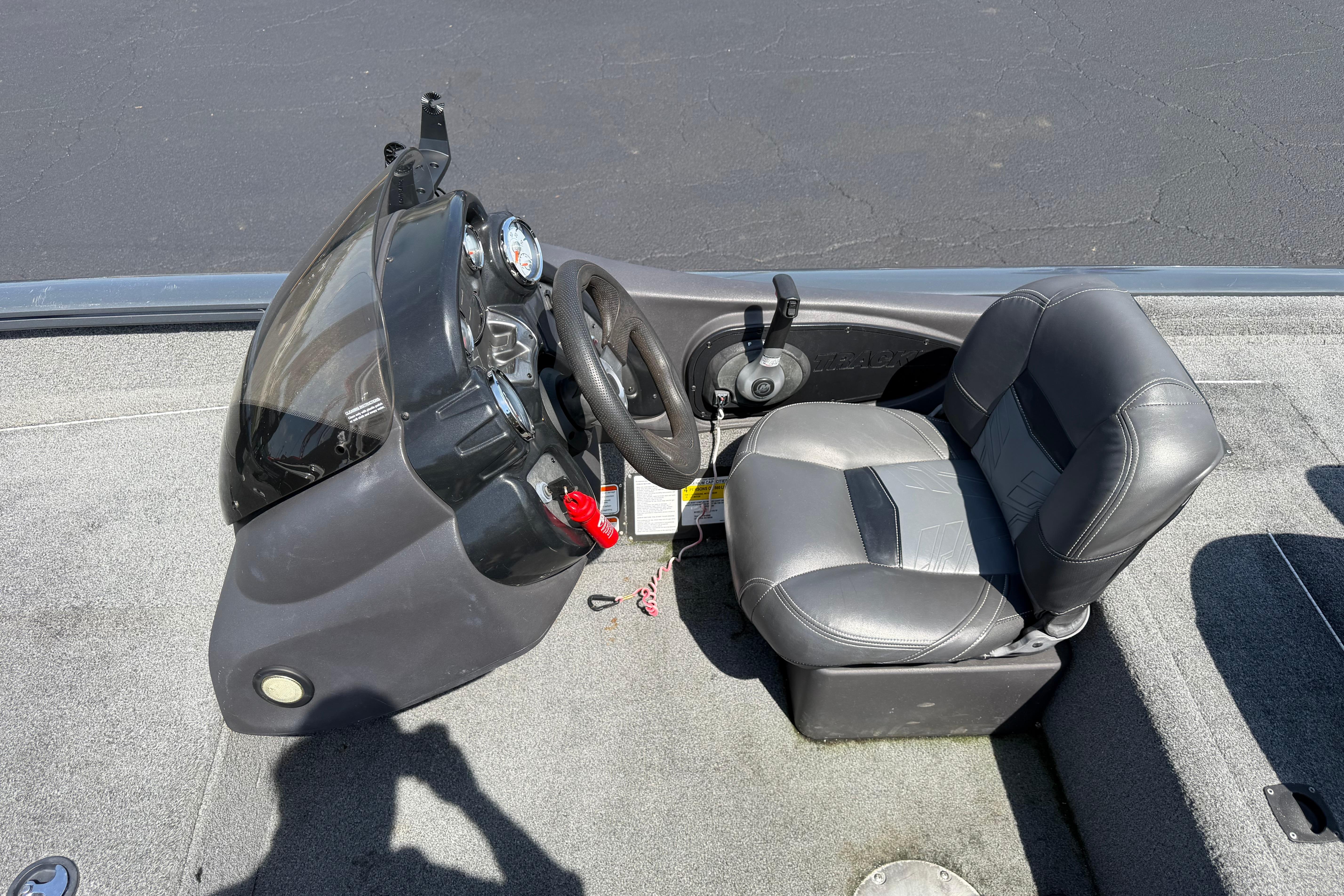 2019 Tracker Pro Team 175 TF boat cockpit with steering wheel and seat.