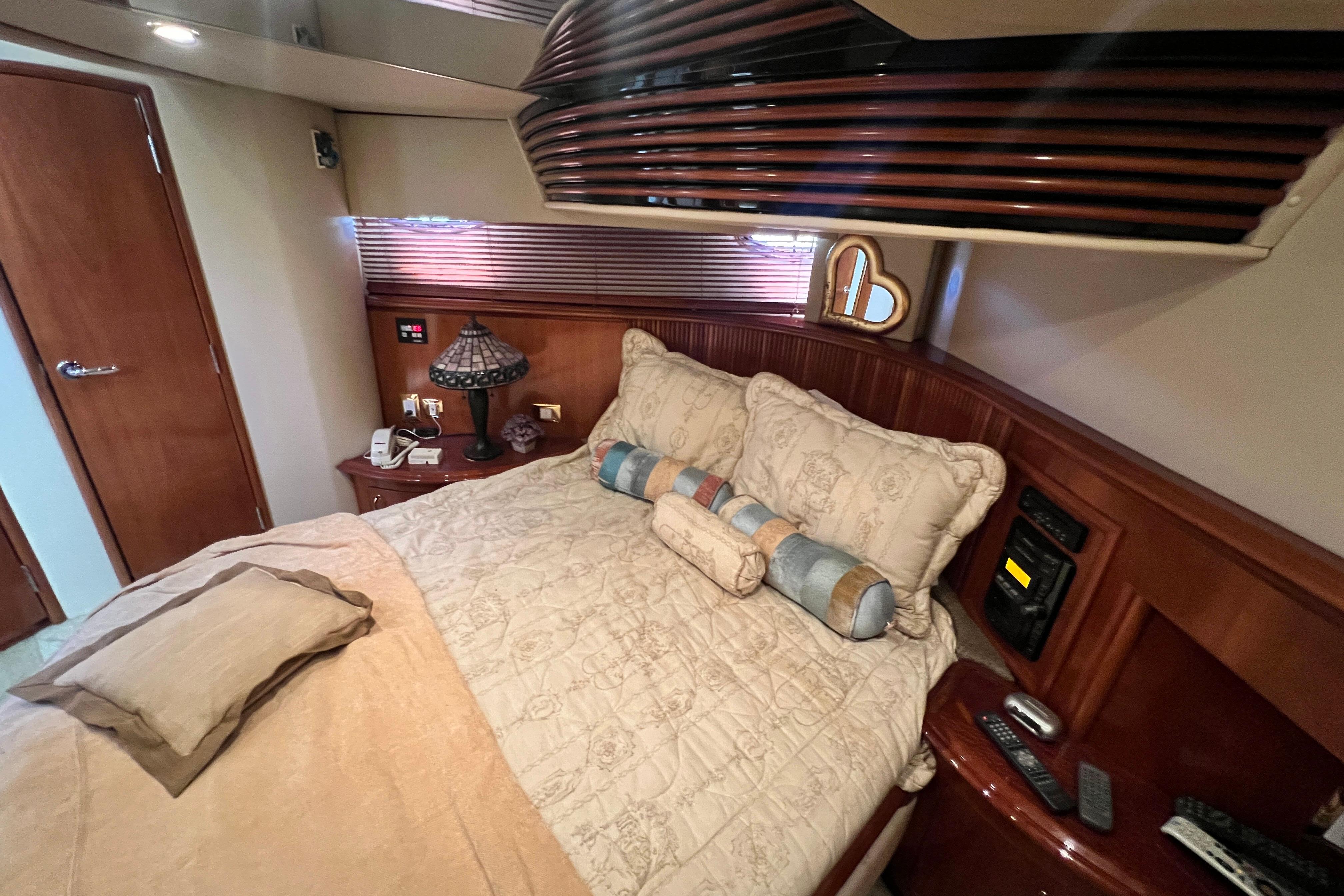 Luxurious bedroom interior of 2003 Carver 450 Voyager Pilothouse yacht with elegant bedding.