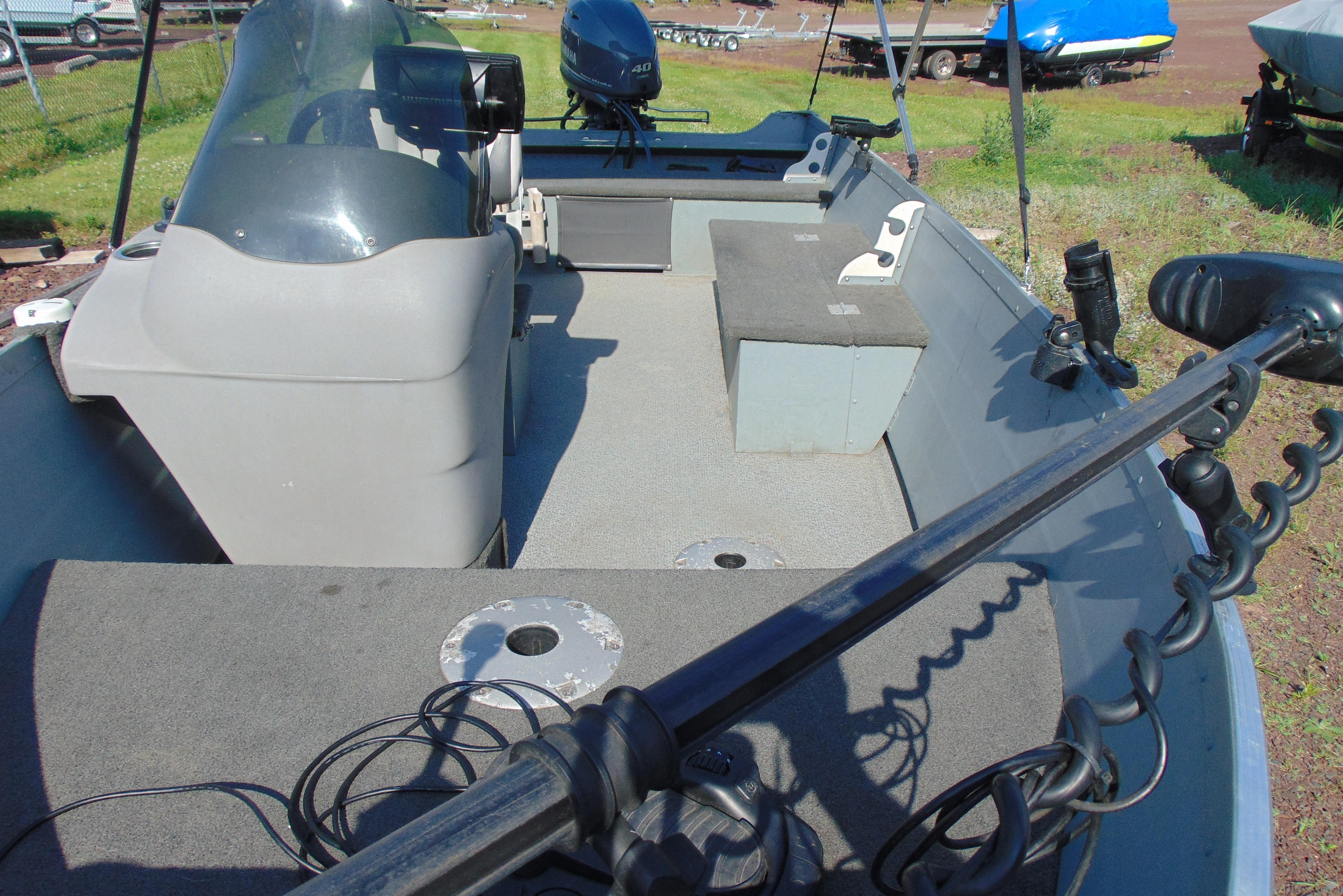 2017 Starcraft SF 16 DLX boat interior with seating and motor, parked on grass.