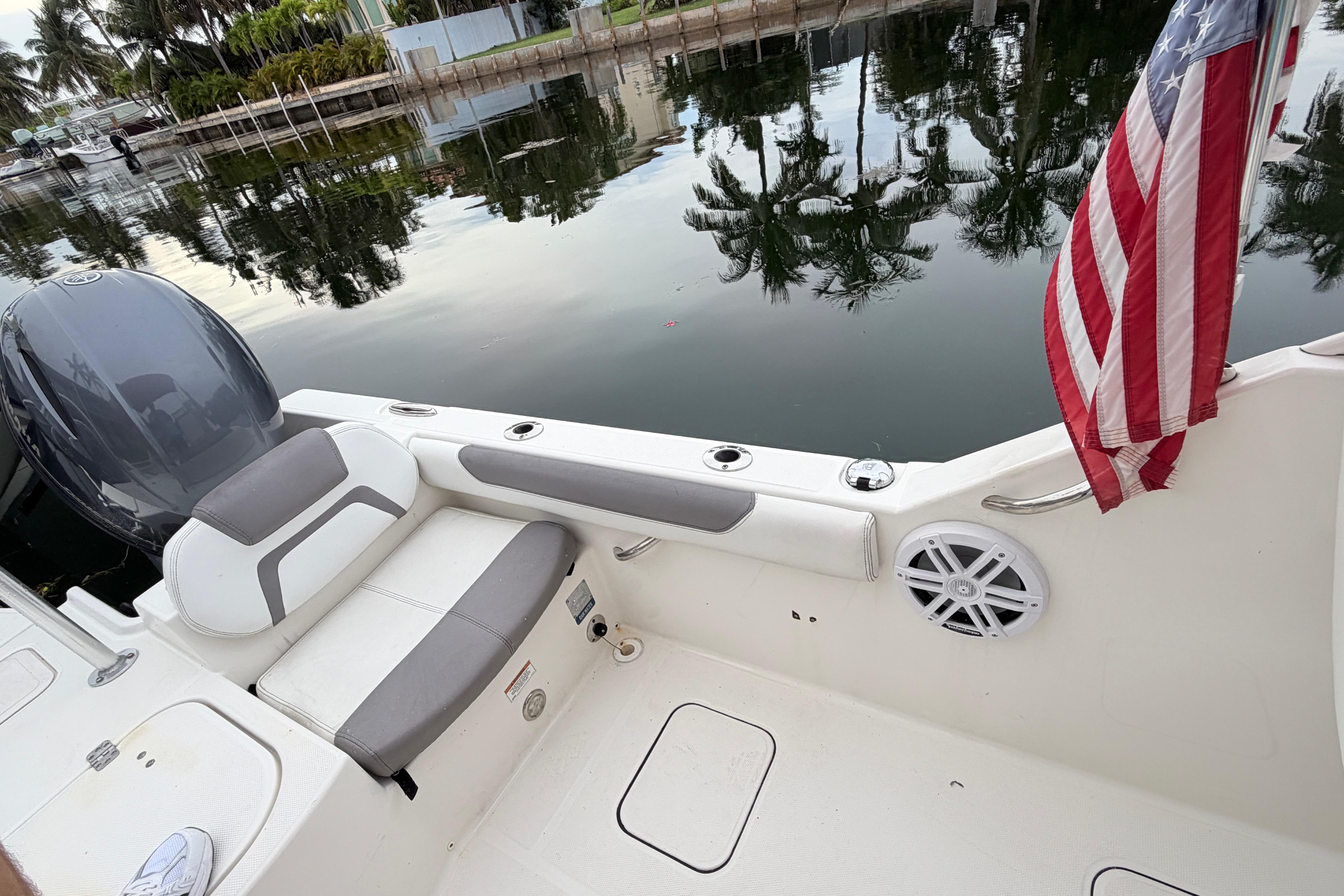 2019 World Cat 230 DC boat interior with American flag and waterfront view.