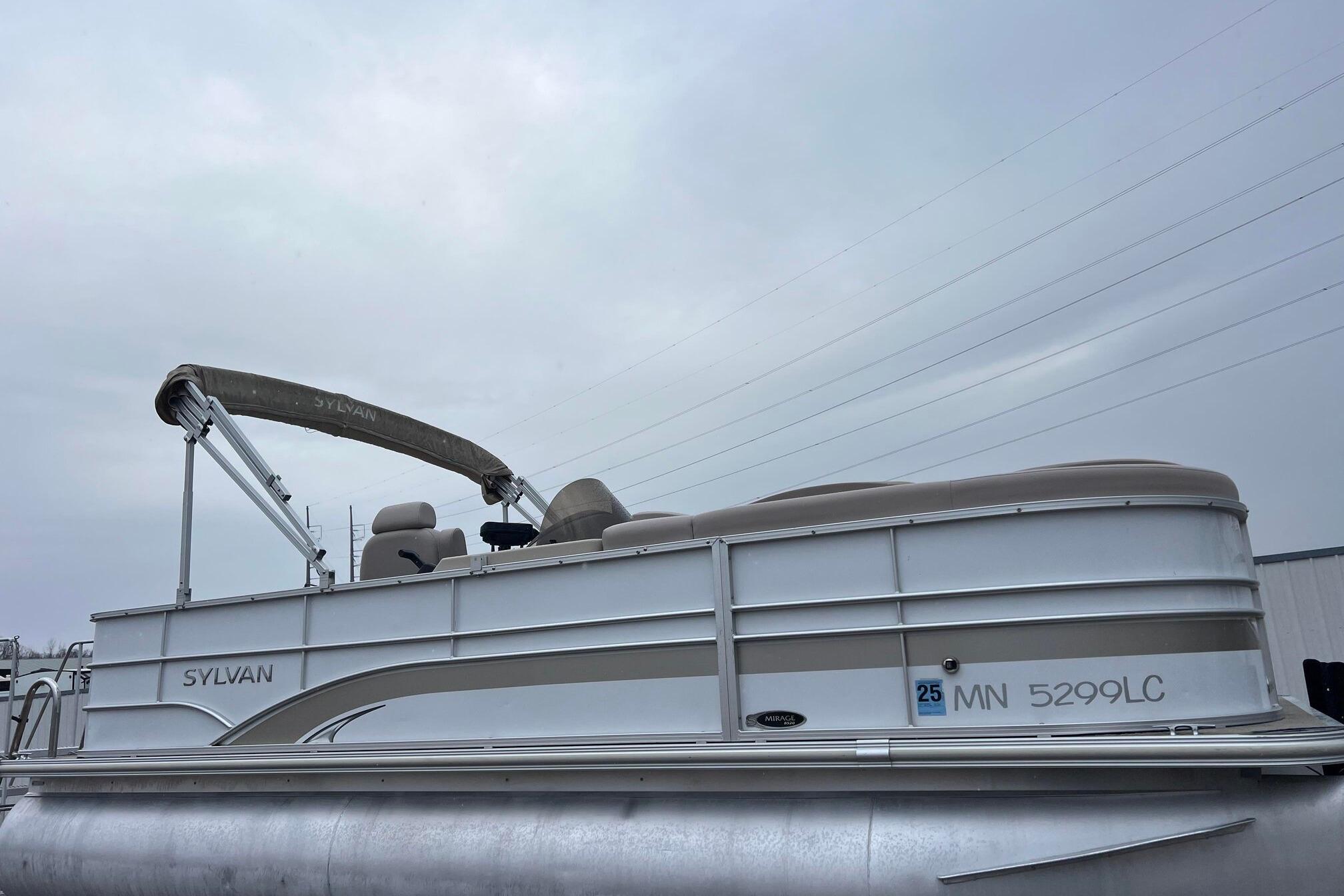 2014 Sylvan Mirage Cruise 8520 CR pontoon boat with canopy, side view.