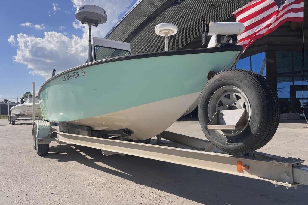 1997 Gravois 20CC boat on trailer with American flag, under clear blue sky.
