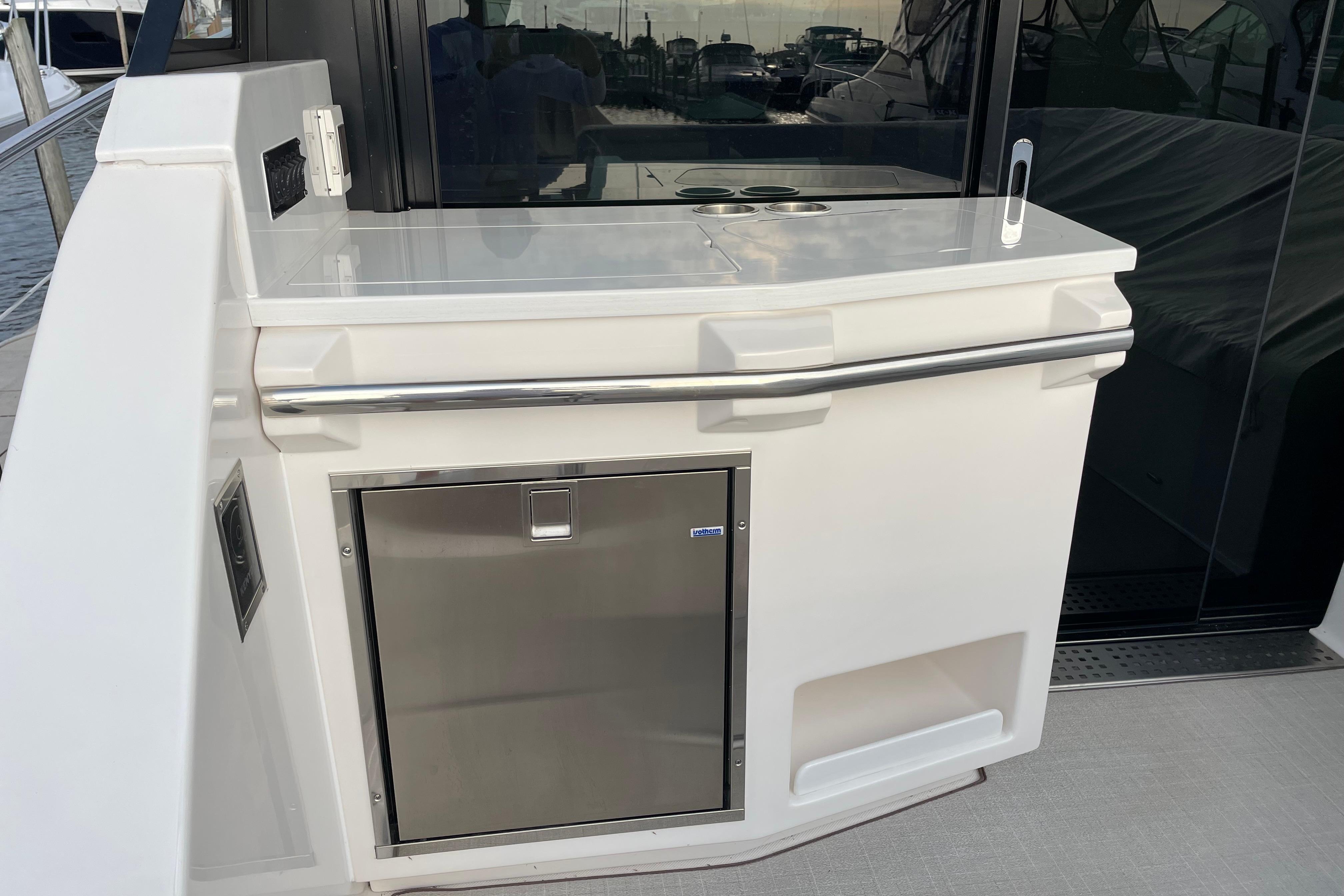 Outdoor kitchenette on 2022 Regal 38 Grande Coupe yacht with stainless steel fridge.
