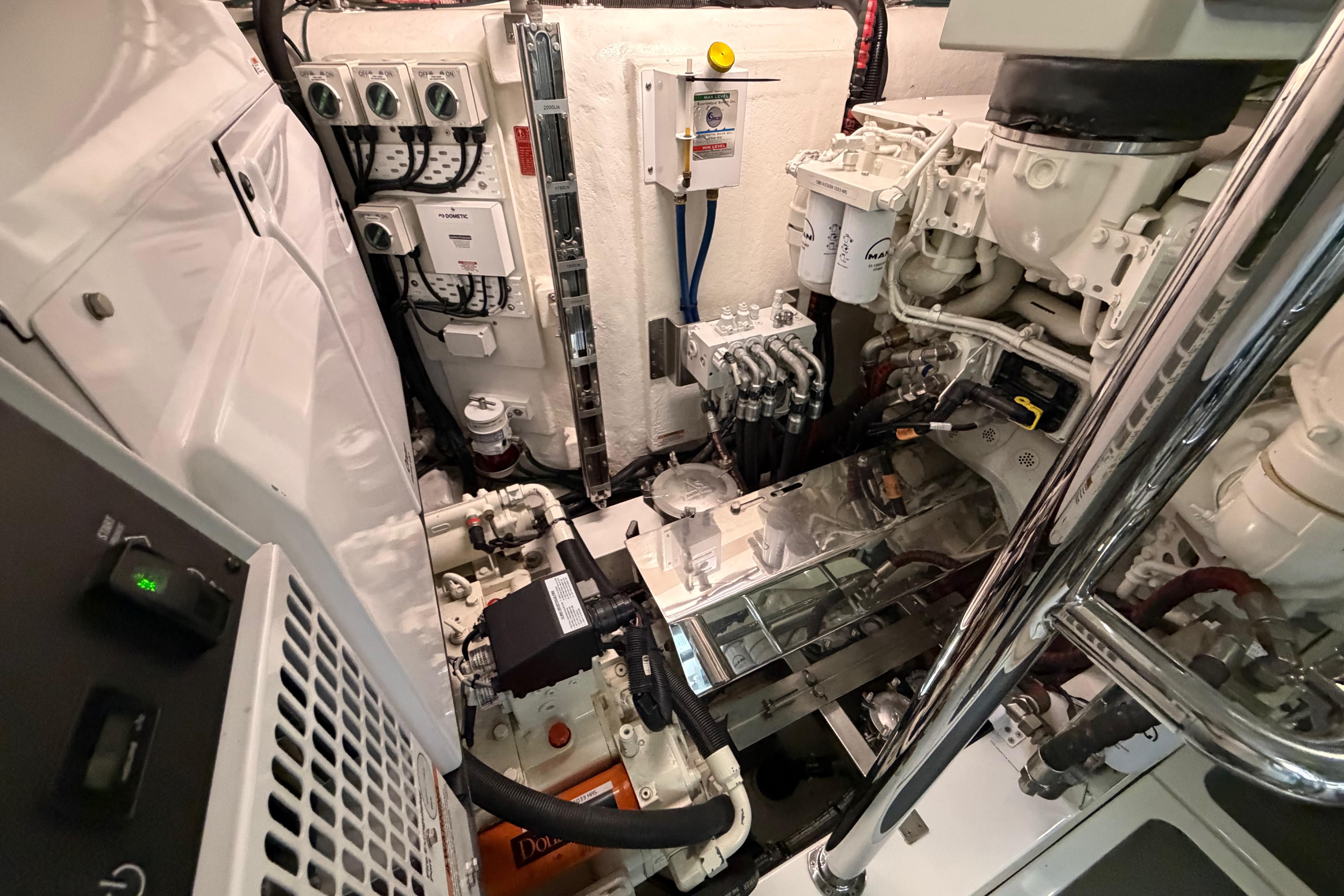 Engine room of 2023 Riviera 645 SUV yacht, showcasing complex machinery and control systems.