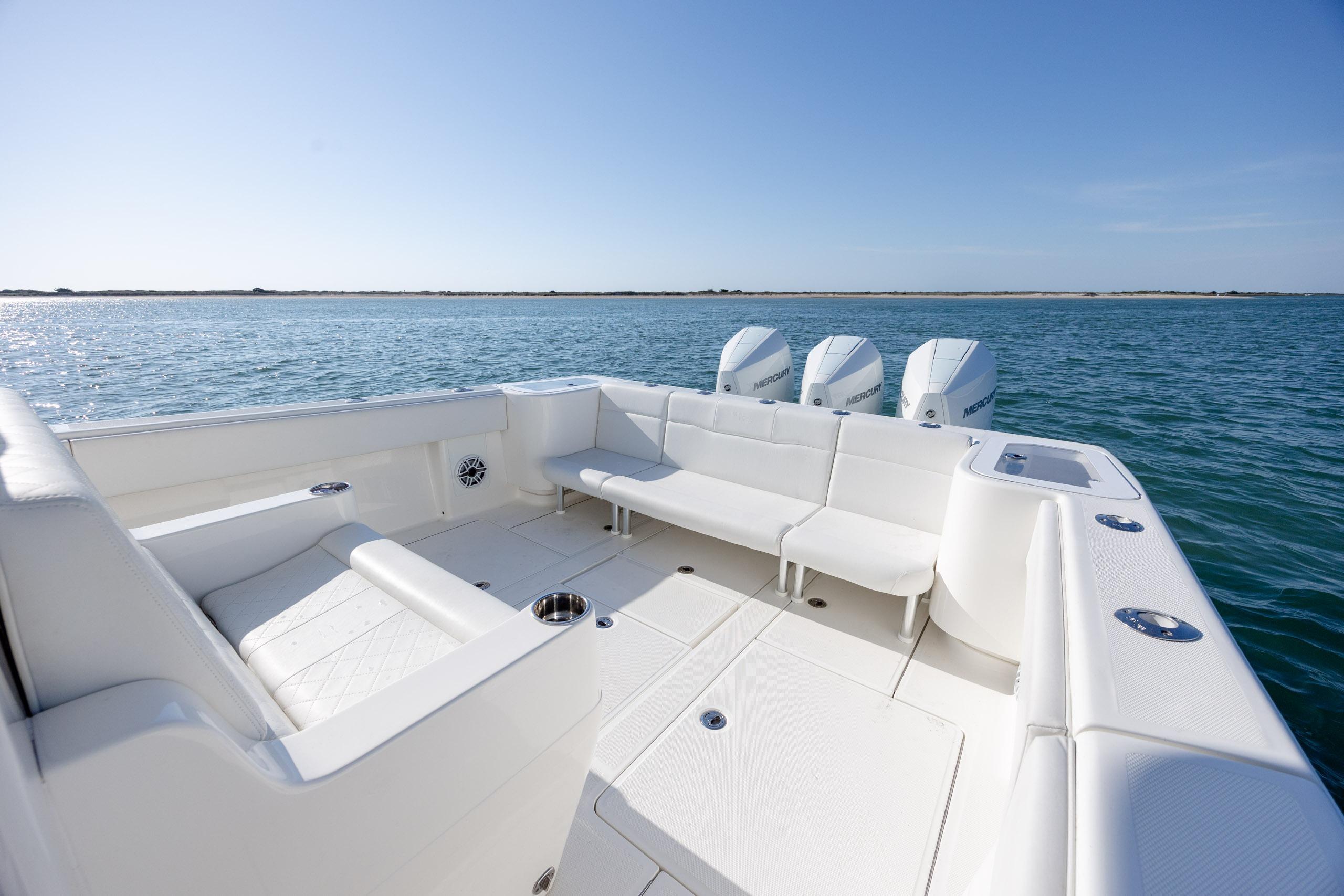2019 SeaVee 370Z boat with spacious seating and four outboard engines on open water.