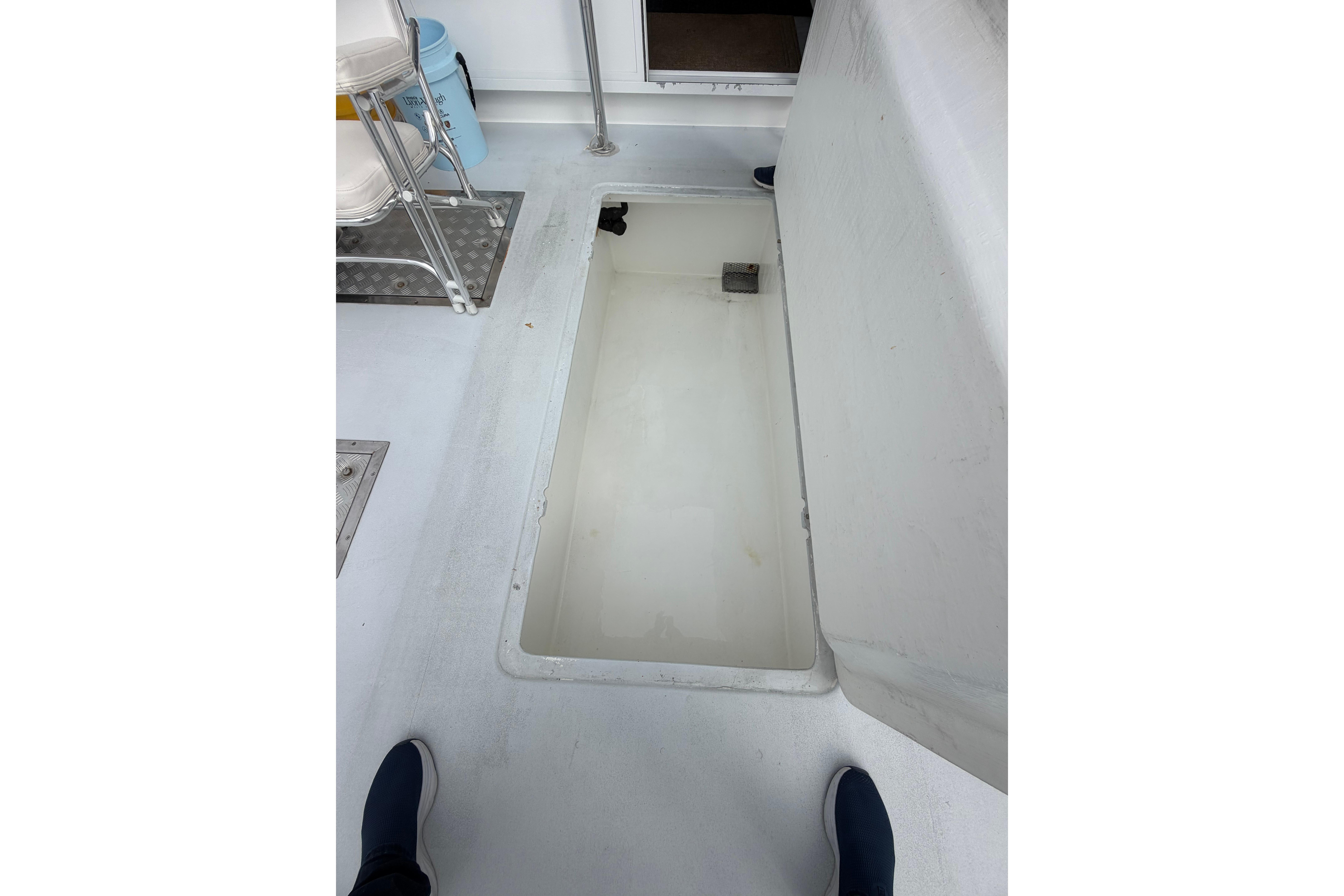 2018 H&H Marine Osmond Beal boat interior with open storage compartment.