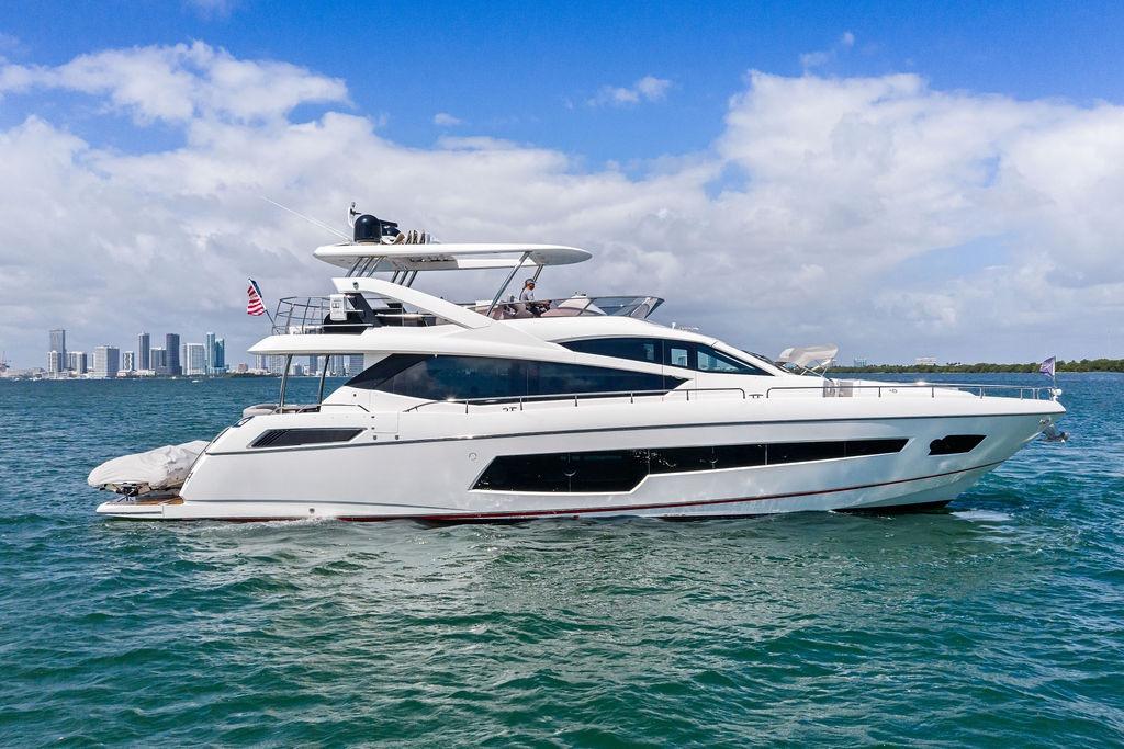 2018 Sunseeker 75 Sport Yacht cruising on blue waters under a clear sky.